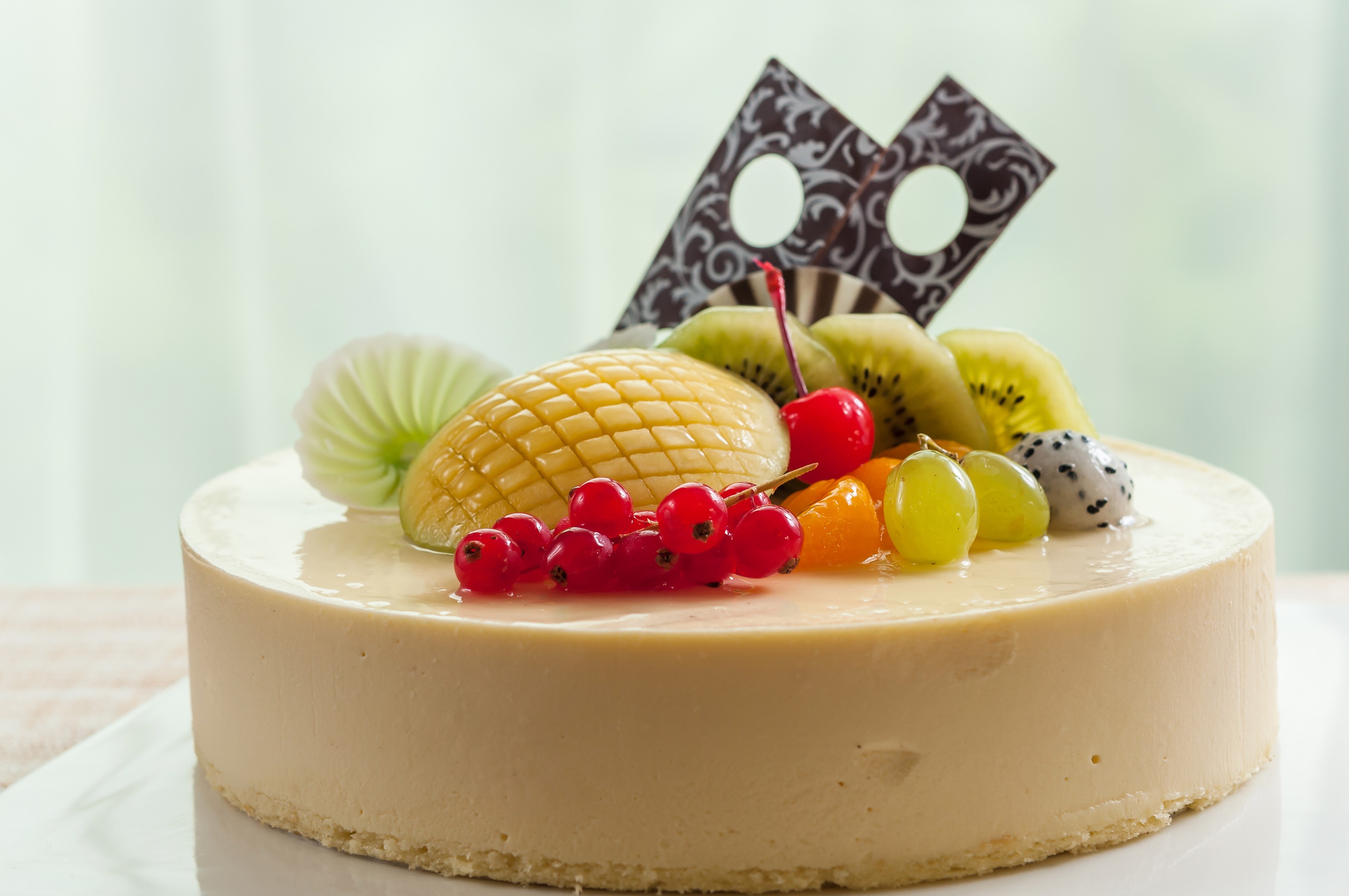 Cream cake with assorted fruits and chocolate decoration HD Wallpaper