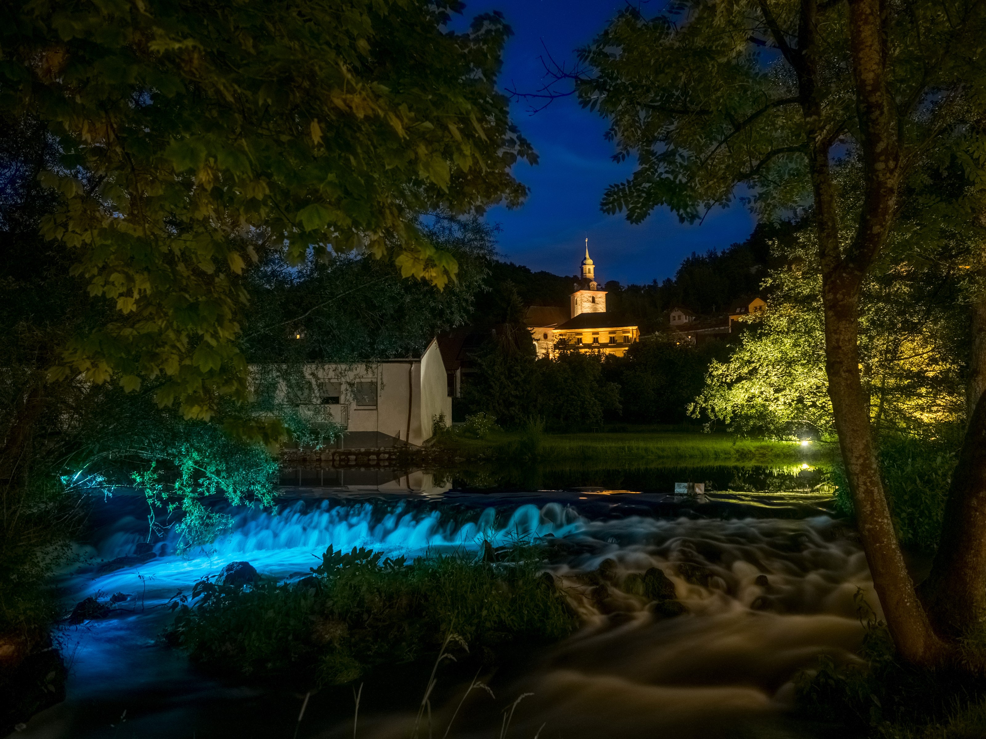 River and buildings at night in Muggendorf, Germany HD Wallpaper