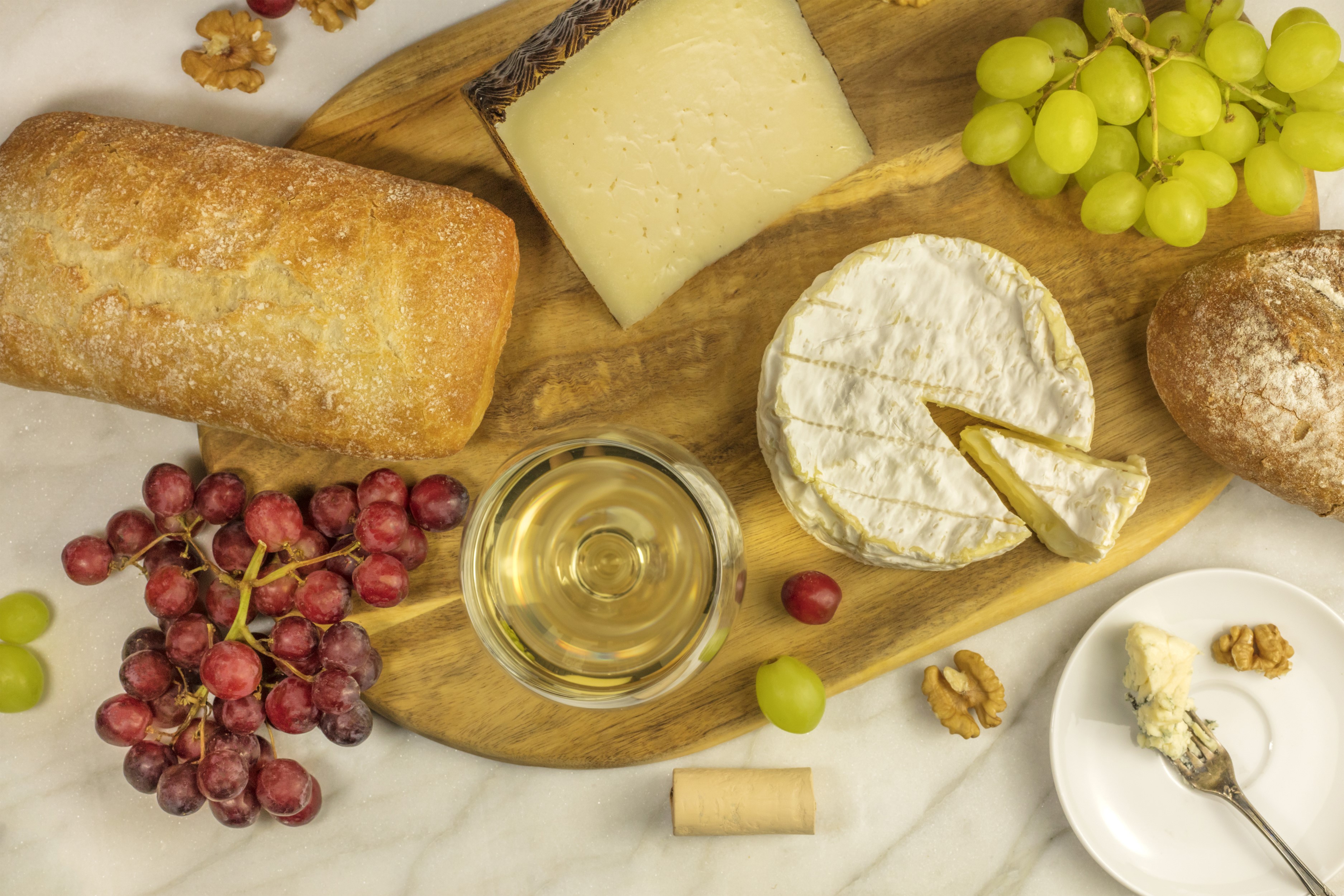 Cheese, Bread, Grapes, and Wine on a Cutting Board HD Wallpaper