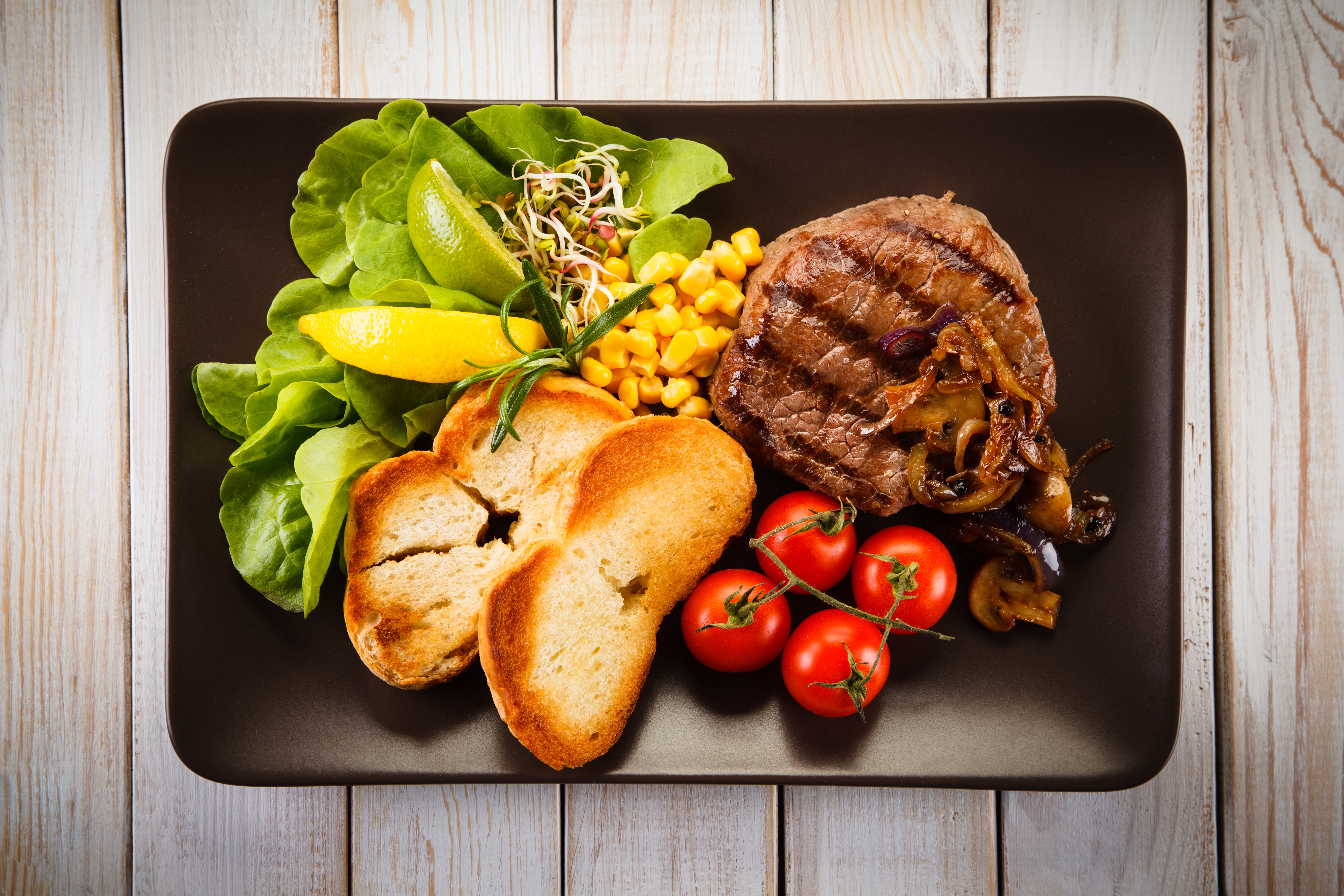 Grilled steak with bread, salad, corn, and tomatoes HD Wallpaper