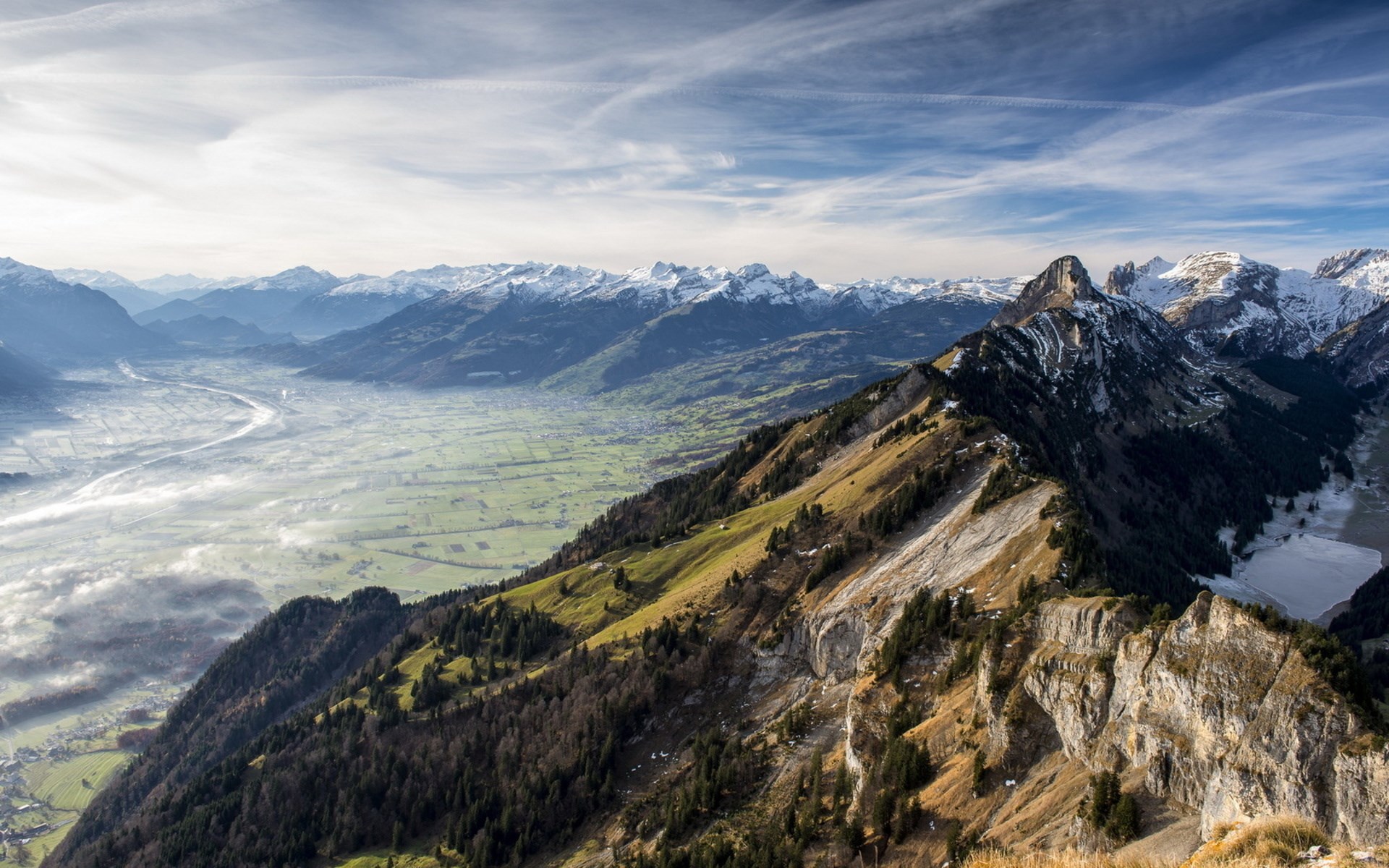Panoramic view of a mountain valley with snow-capped peaks HD Wallpaper