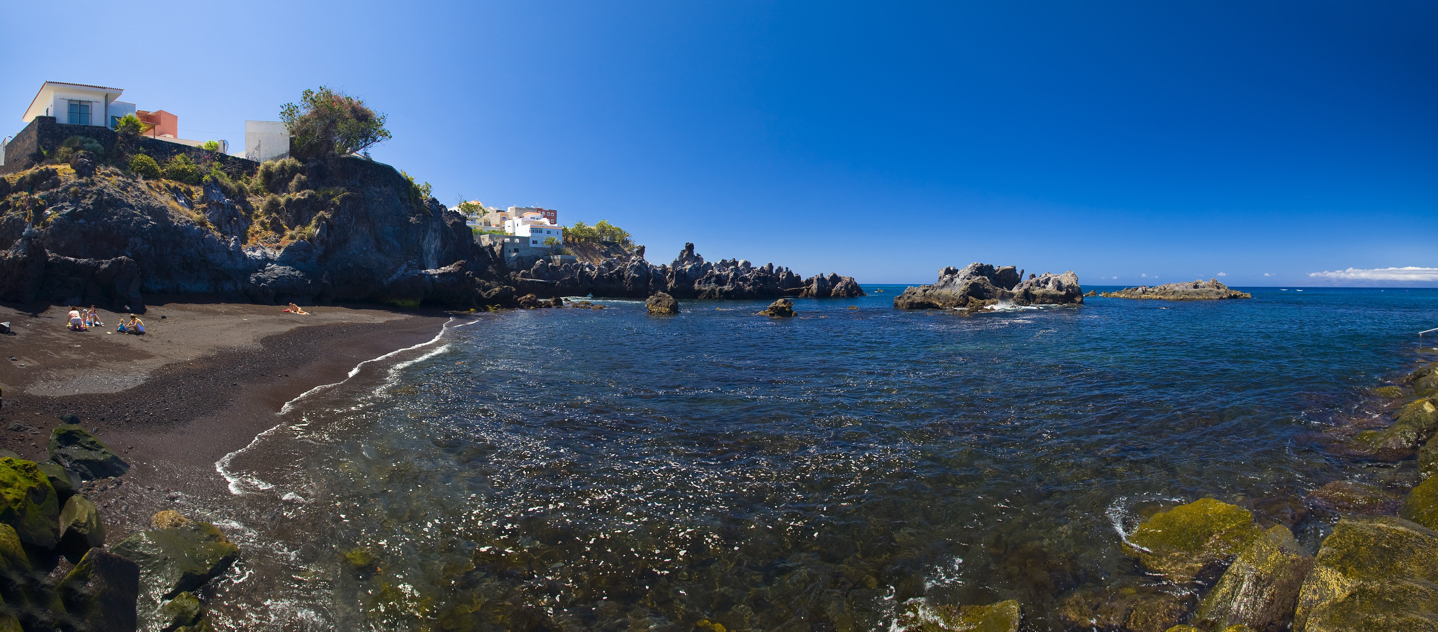 Black sand beach with rocky coast and houses in Tenerife, Spain HD Wallpaper