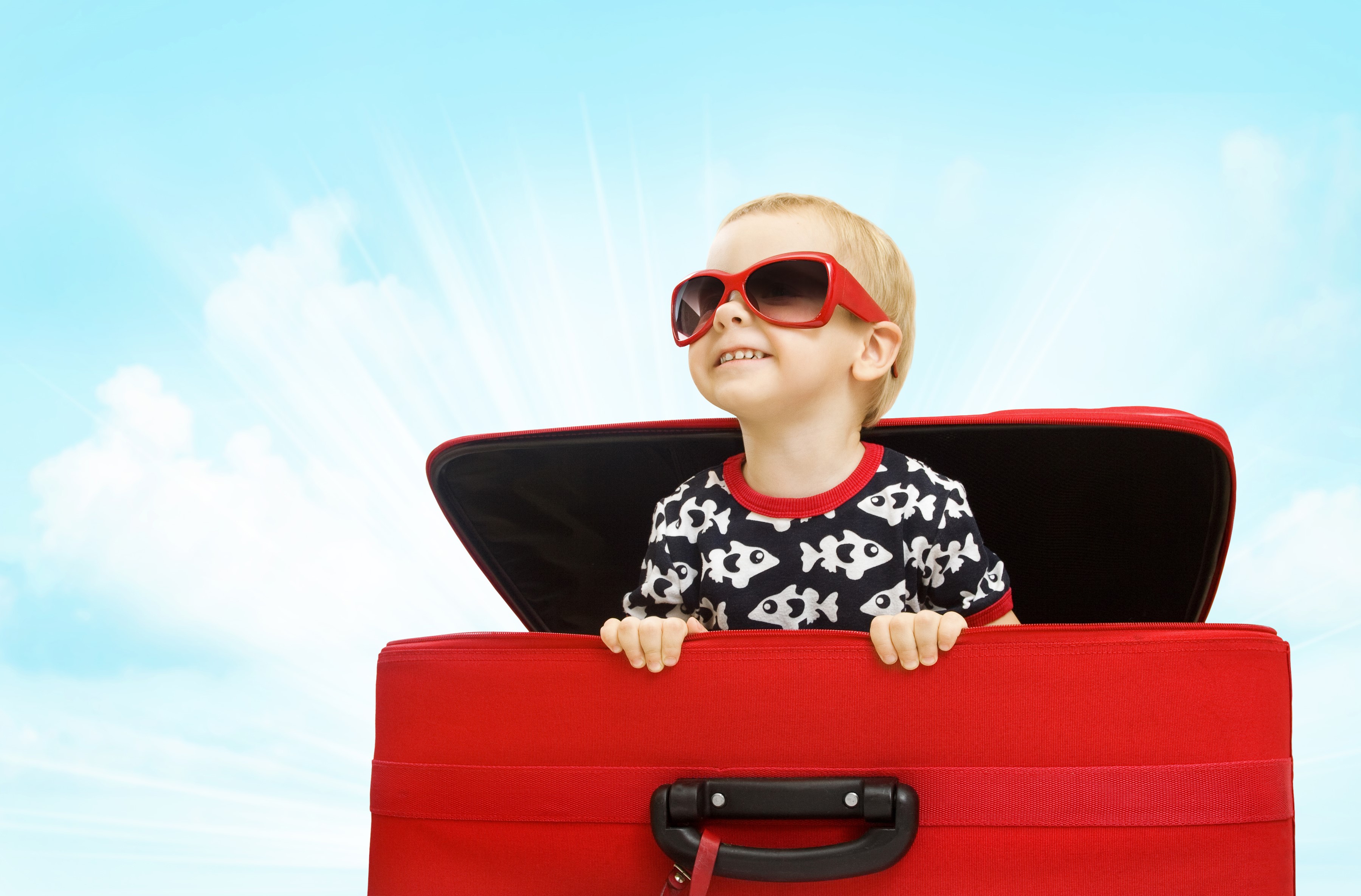 Boy in sunglasses in a red suitcase HD Wallpaper