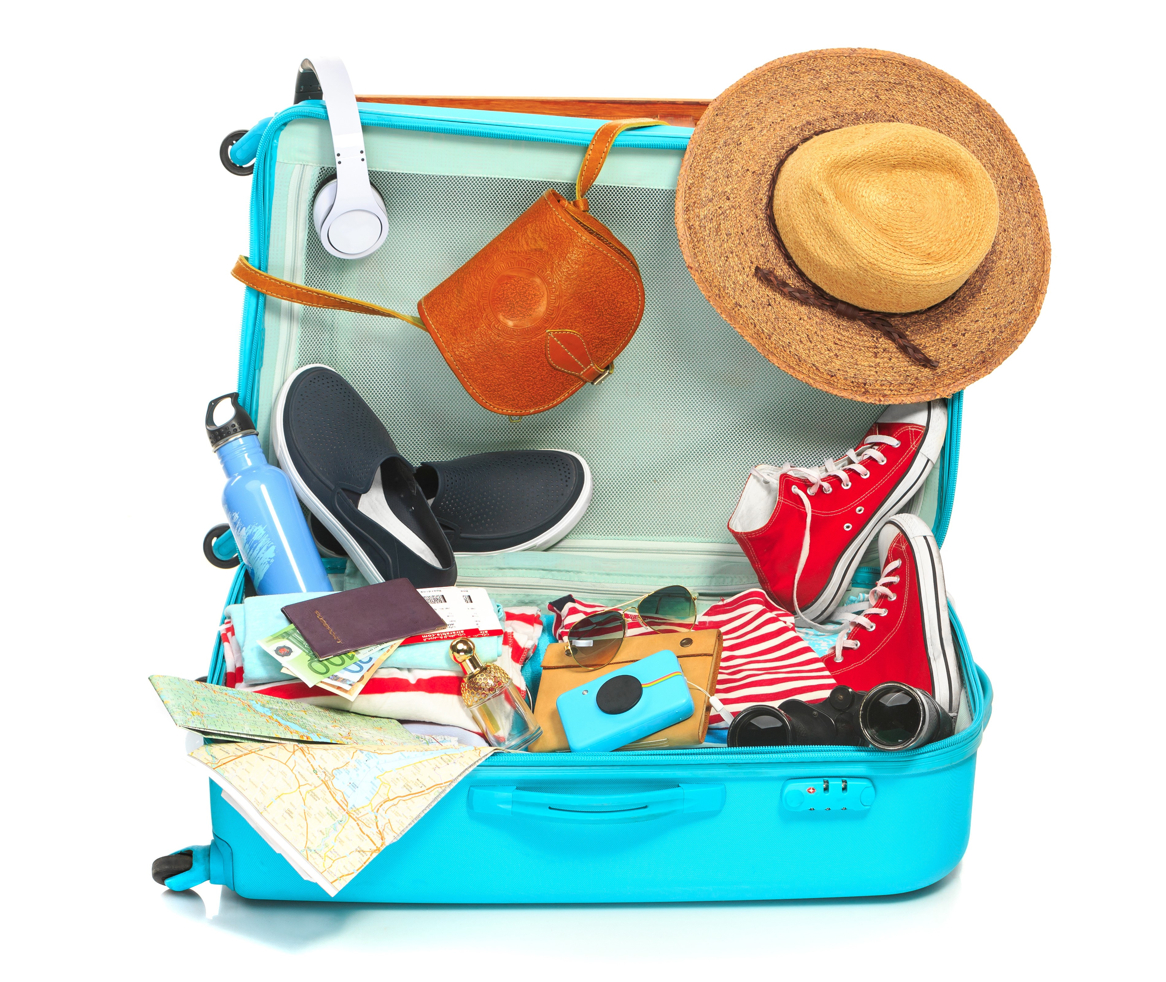 Open suitcase packed for travel with clothing and accessories HD Wallpaper