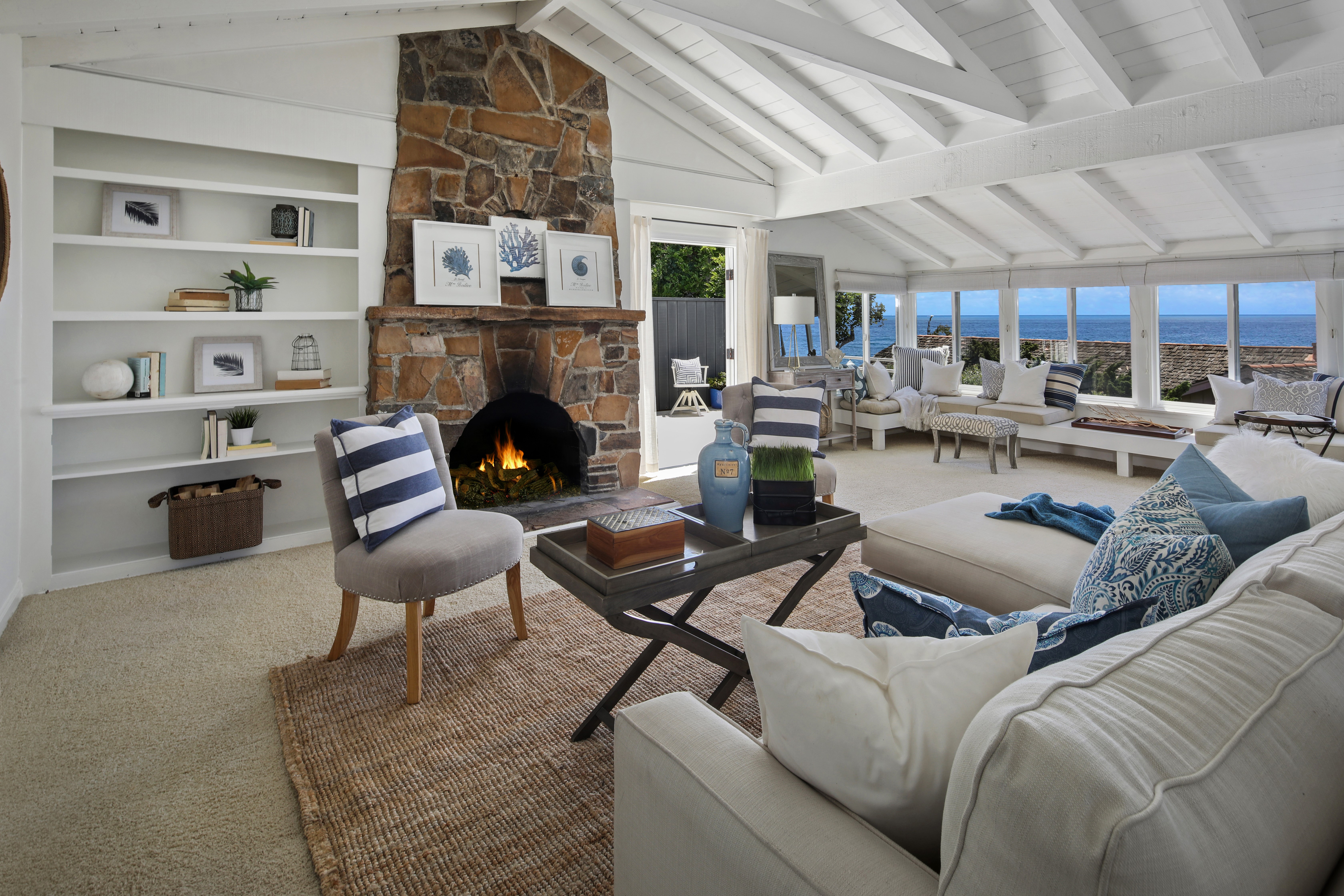 Living room with fireplace and ocean view HD Wallpaper