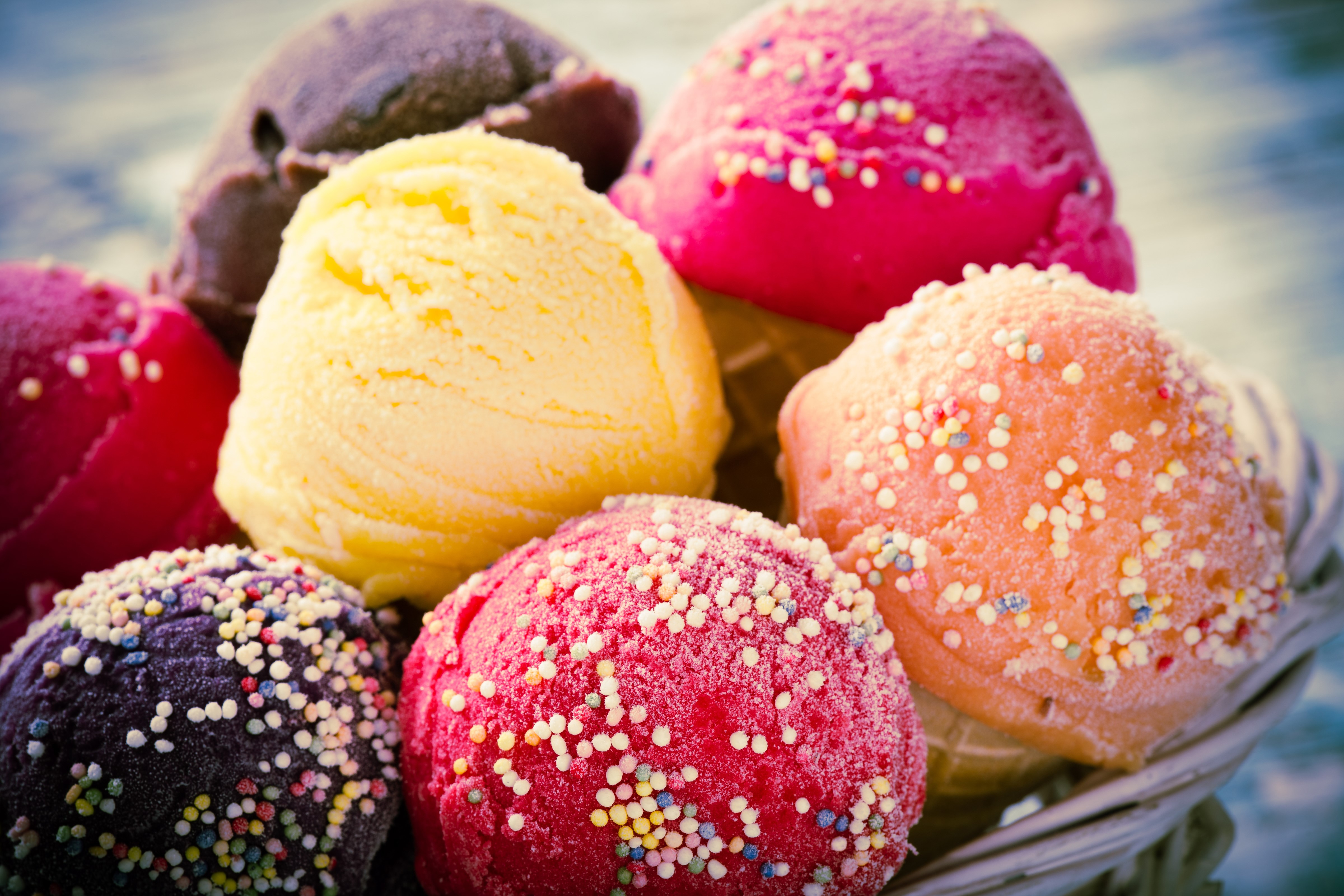Assortment of colorful ice cream scoops with sprinkles HD Wallpaper