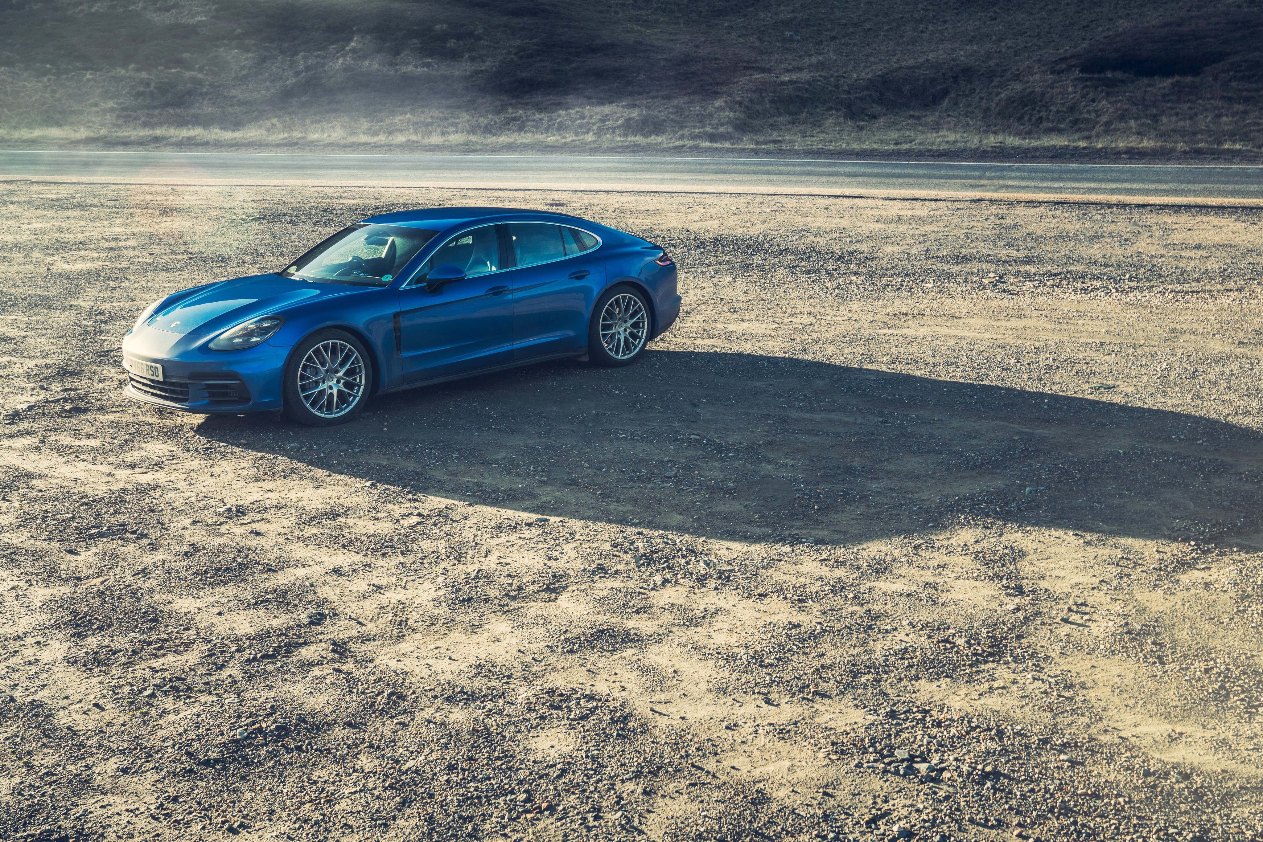 Blue 2016 Porsche Panamera 4S on gravel HD Wallpaper