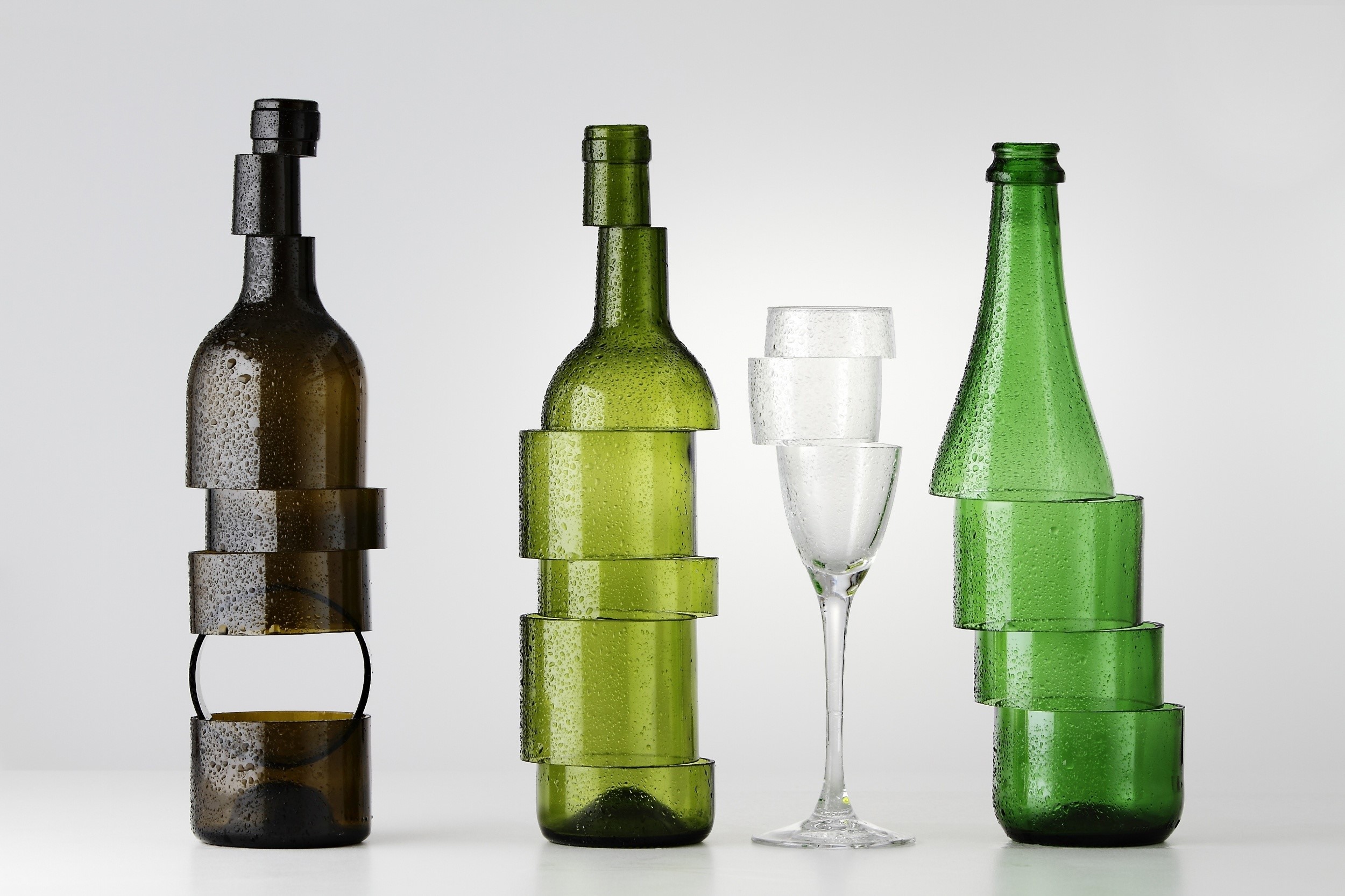 Sliced glass bottles and stemware on gray background HD Wallpaper