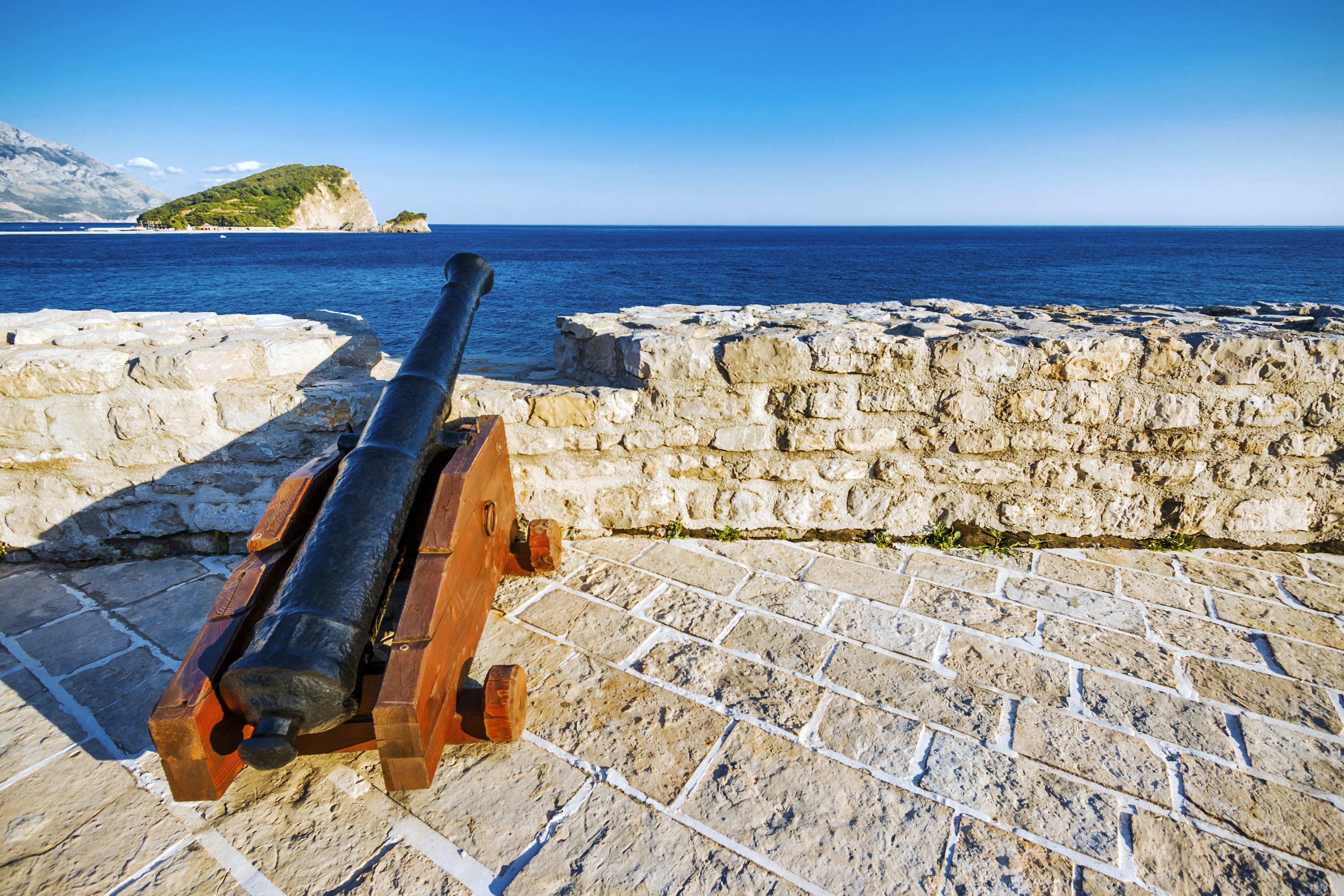 Cannon on stone wall overlooking the sea in Budva, Montenegro HD Wallpaper