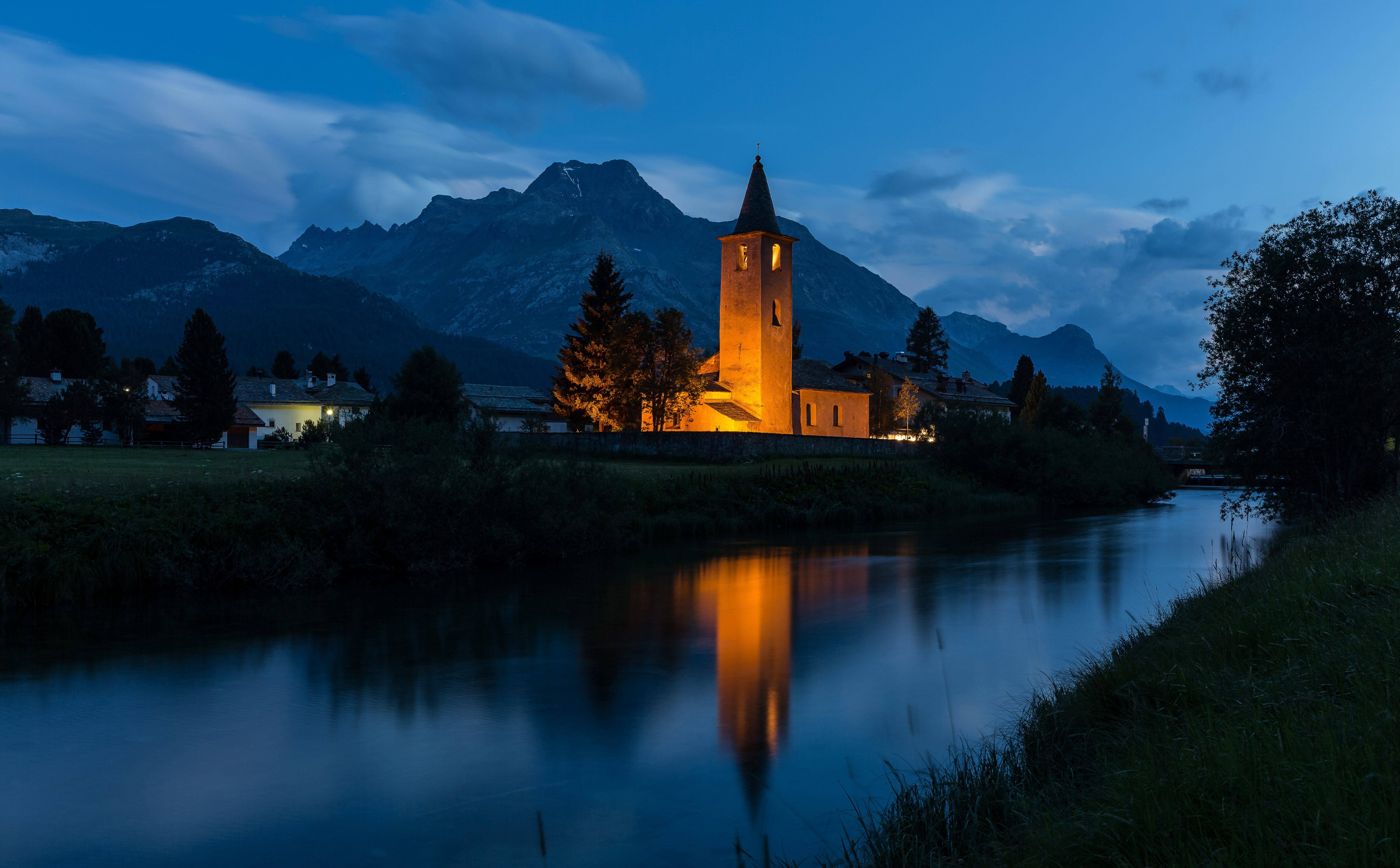 Church and mountains by the river at night in Sils, Switzerland HD Wallpaper