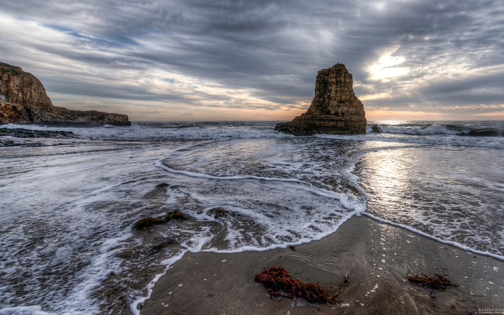 Rocky sea stack and waves at sunset HD Wallpaper