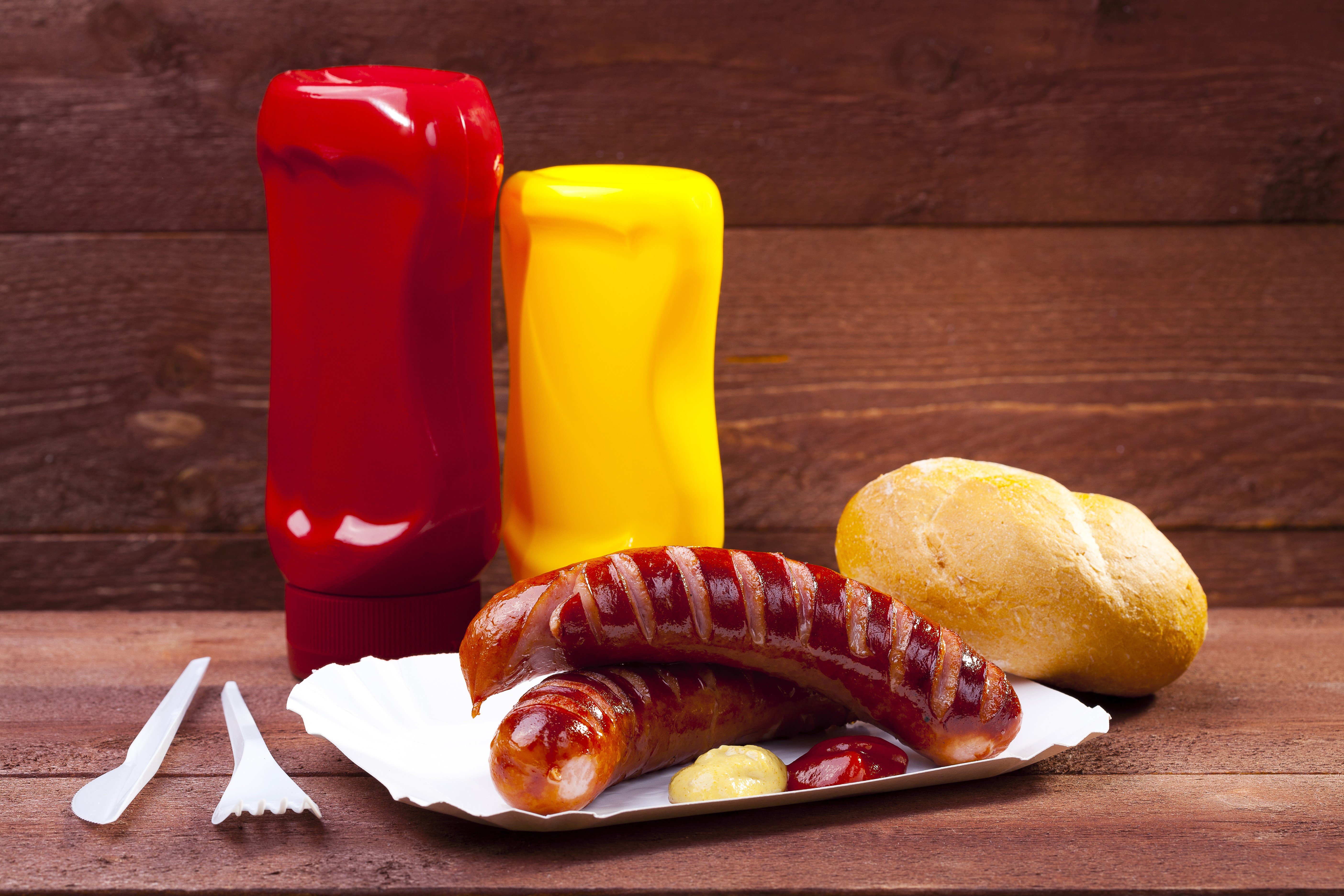 Sausages with Buns and Condiments on Wood HD Wallpaper
