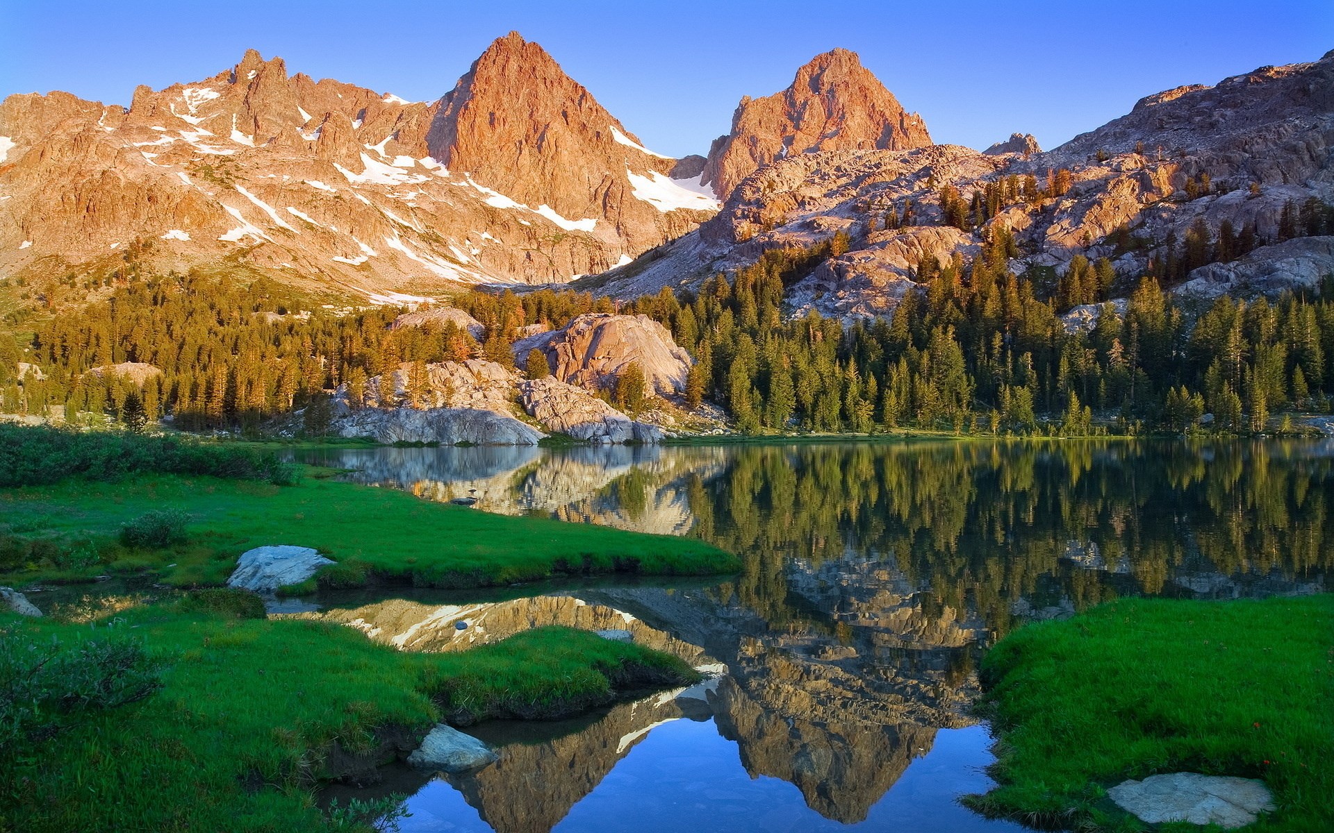Mountain peaks reflected in a lake at sunrise HD Wallpaper