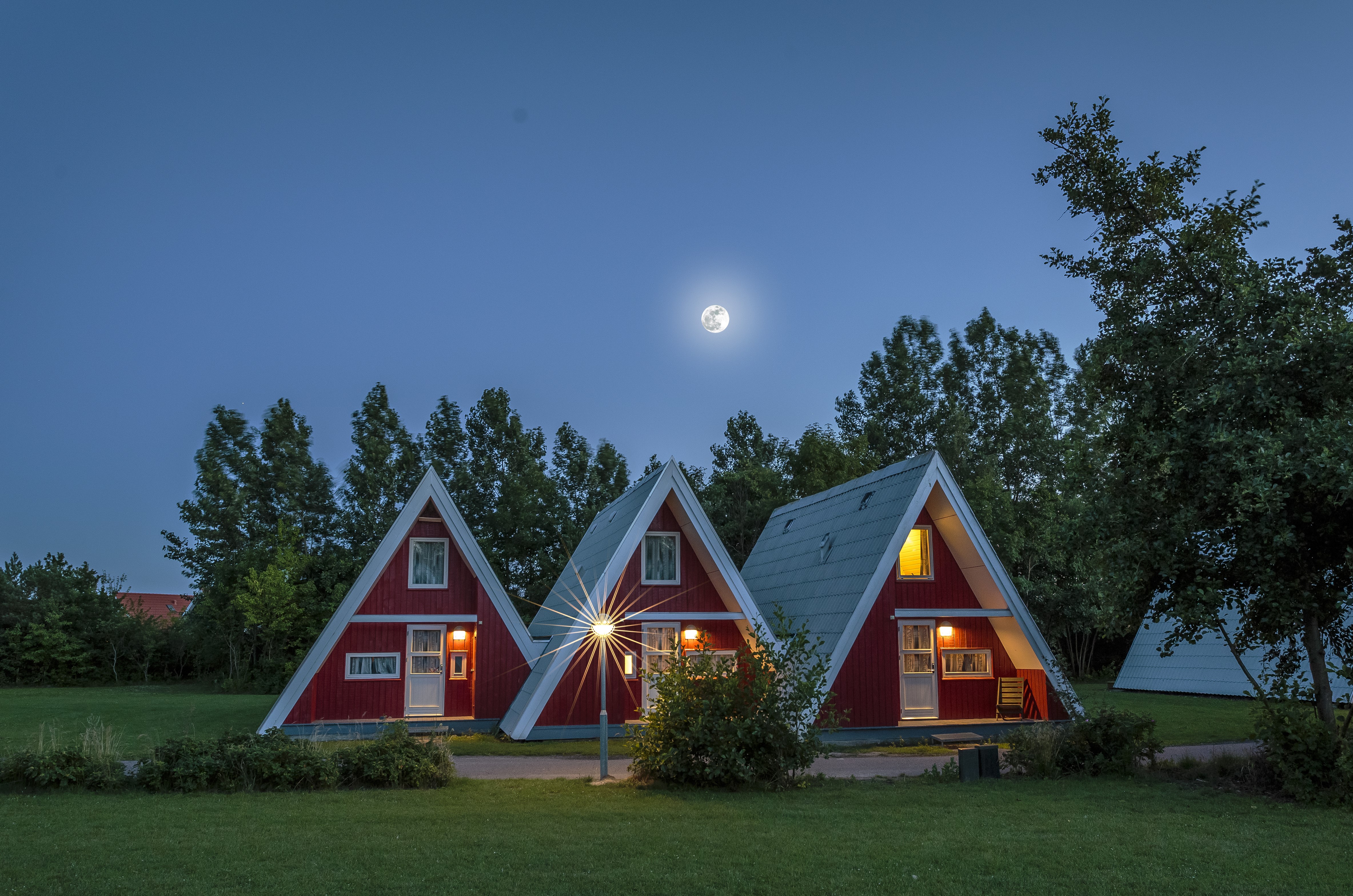 A-frame houses at night with moon HD Wallpaper
