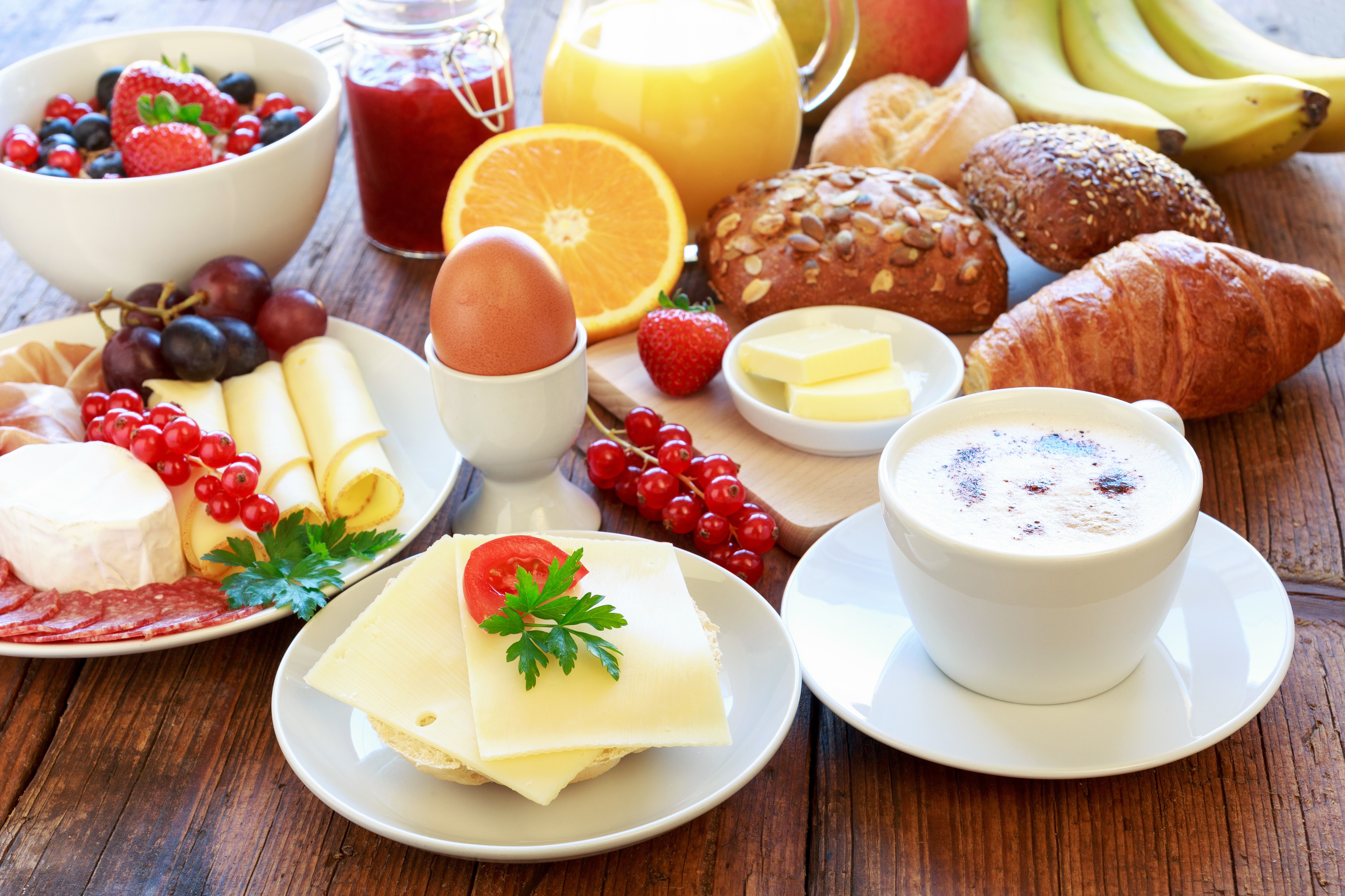 Breakfast spread with coffee, fruits, cheese, and pastries HD Wallpaper