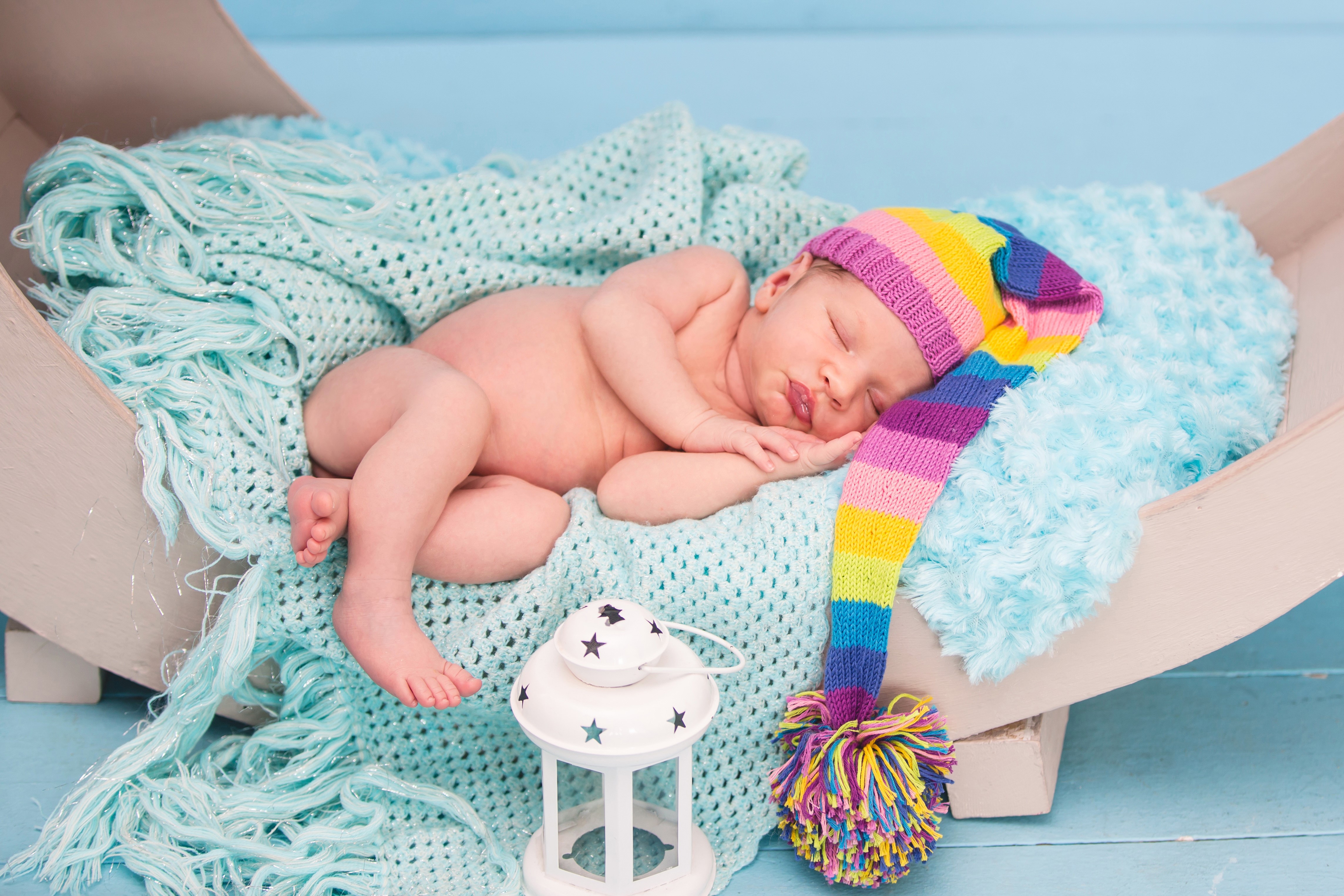 Newborn baby sleeping in a colorful winter hat HD Wallpaper