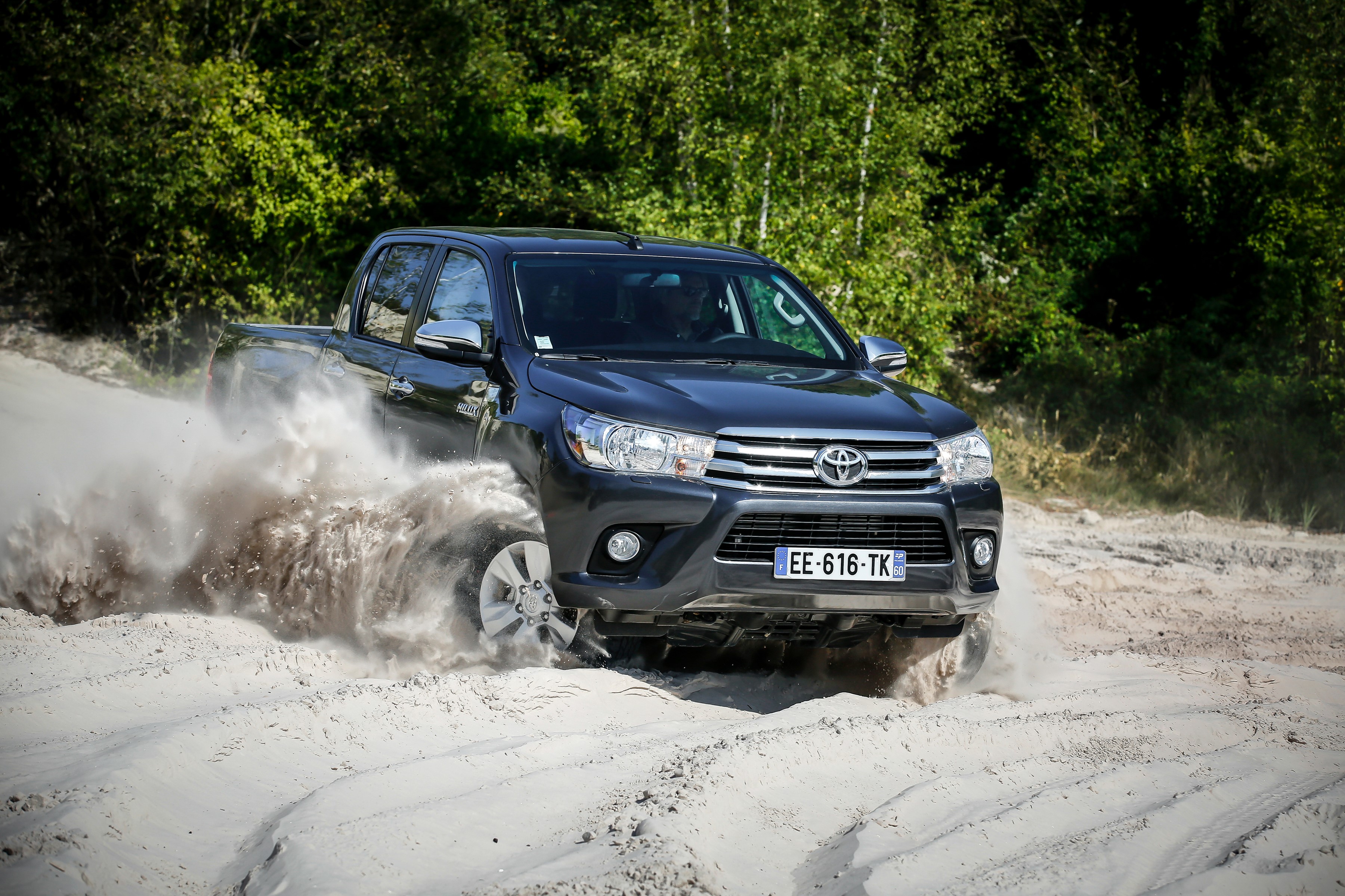 Dark Grey Toyota Hilux 4x4 Double Cab driving on sand HD Wallpaper