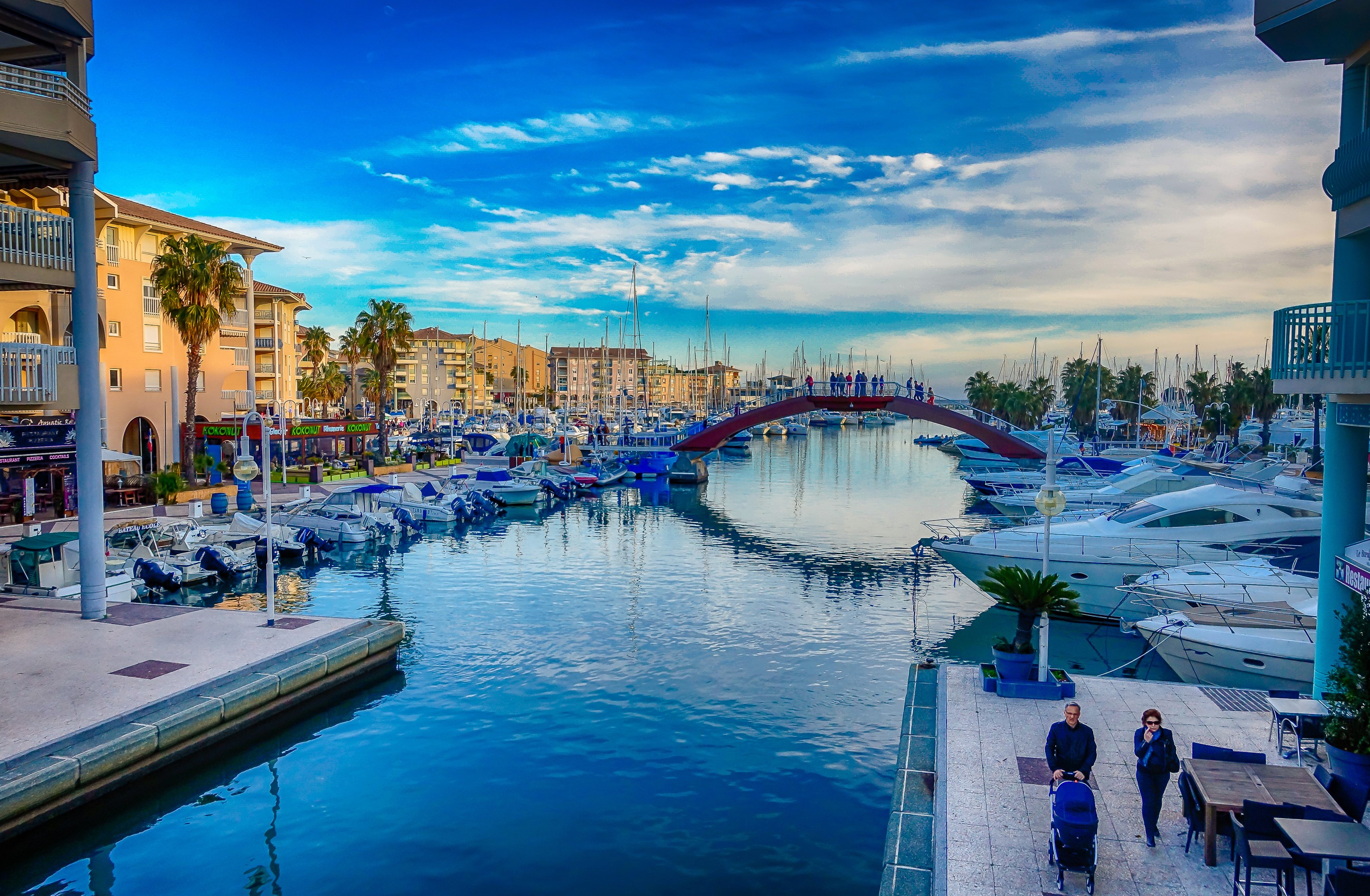 Boats docked in a canal with a bridge in France HD Wallpaper
