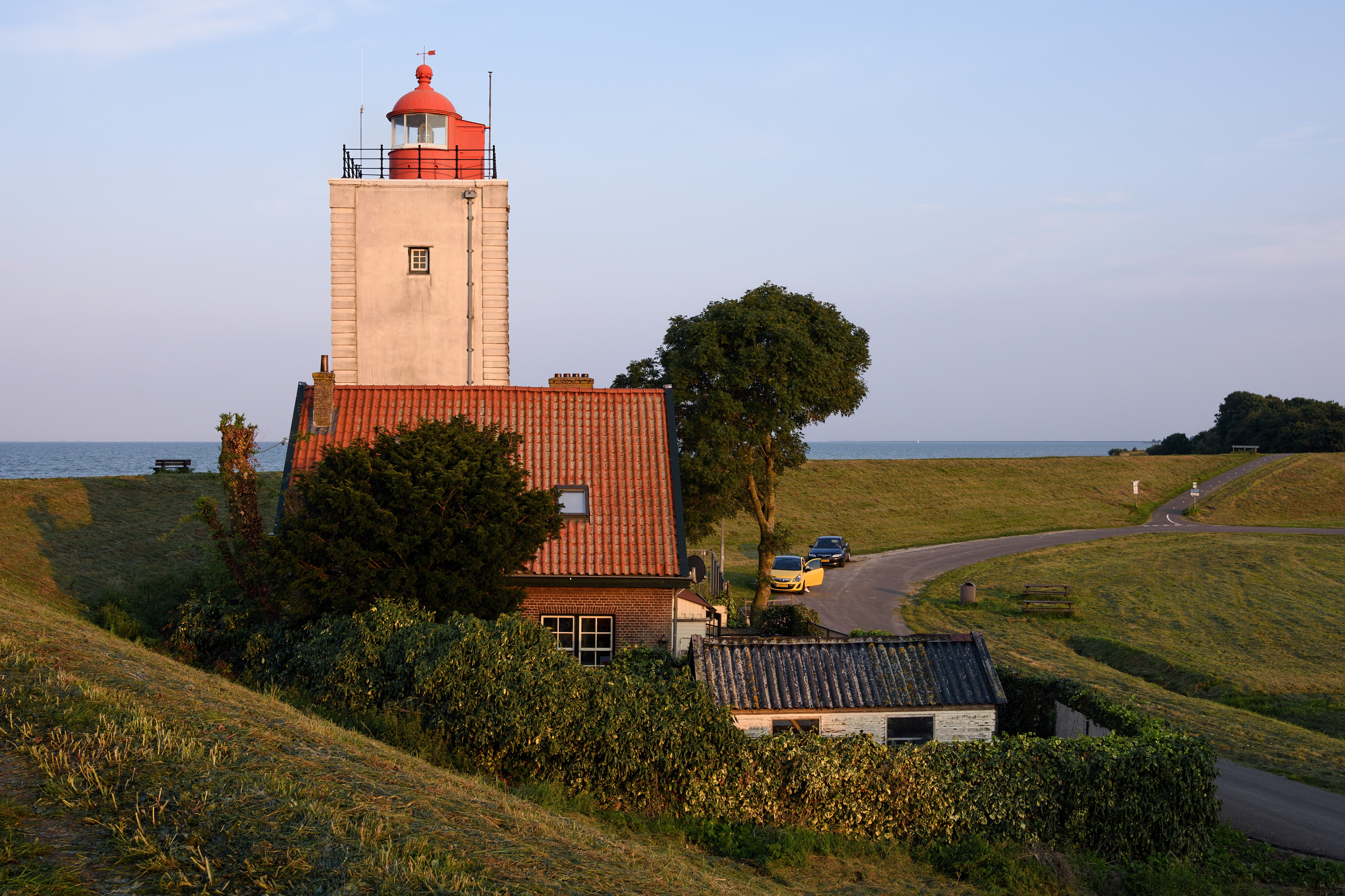Lighthouse and houses on IJsselmeer, Netherlands HD Wallpaper