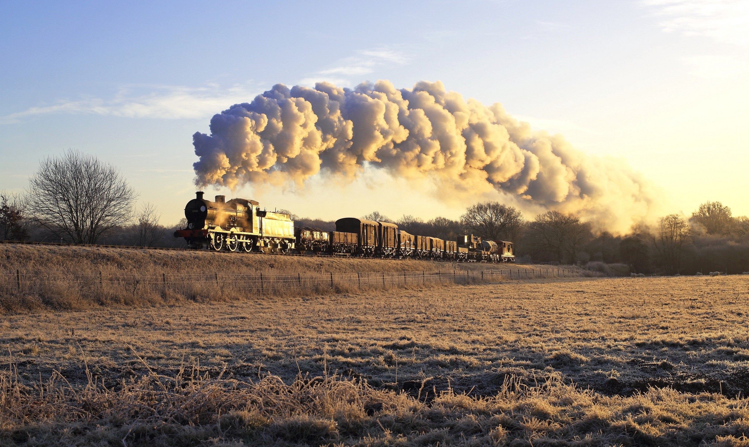 Steam train with smoke in a frosty field HD Wallpaper