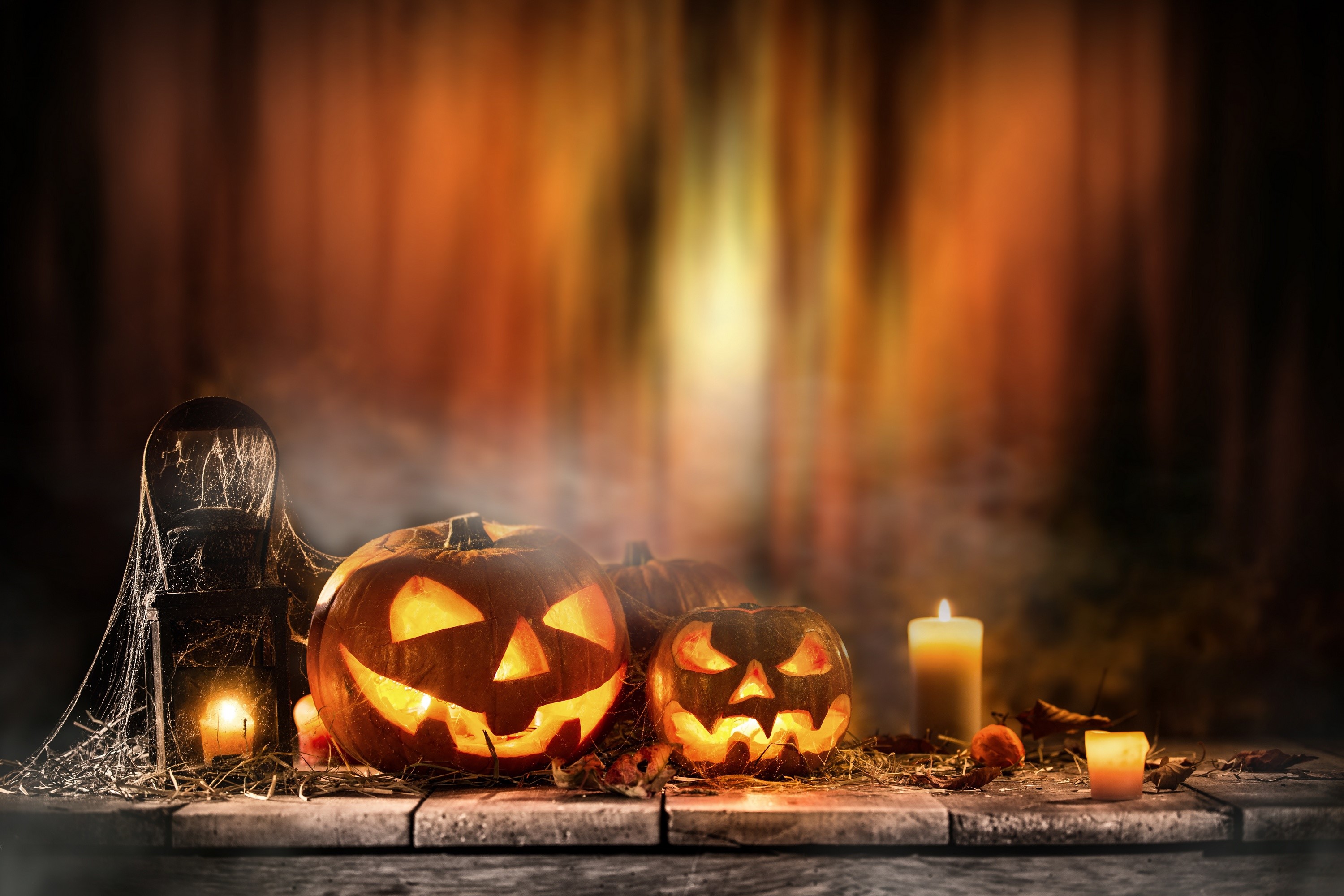 Halloween pumpkins and candles on a wooden table HD Wallpaper
