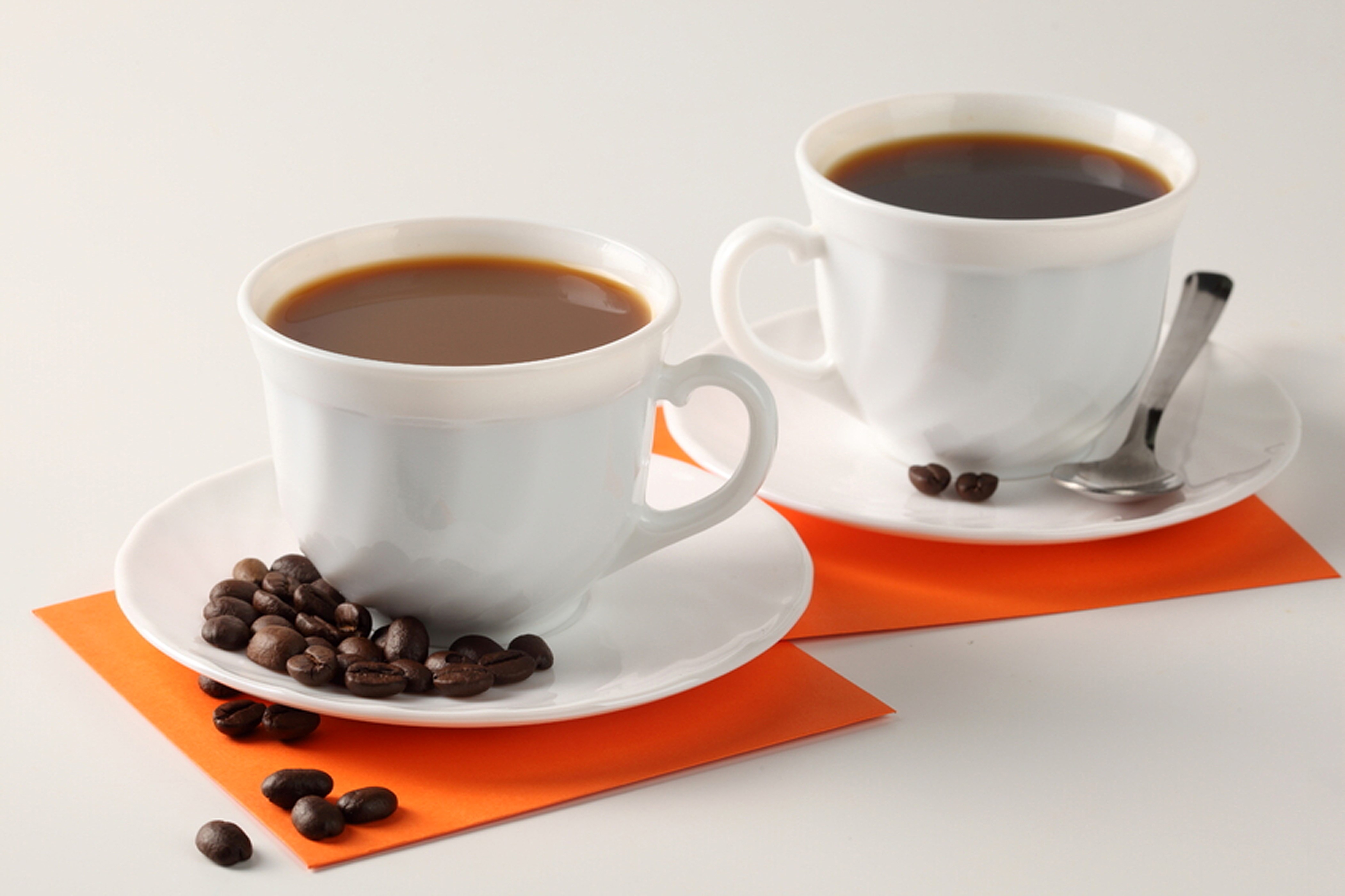 Two cups of coffee with coffee beans and a spoon HD Wallpaper