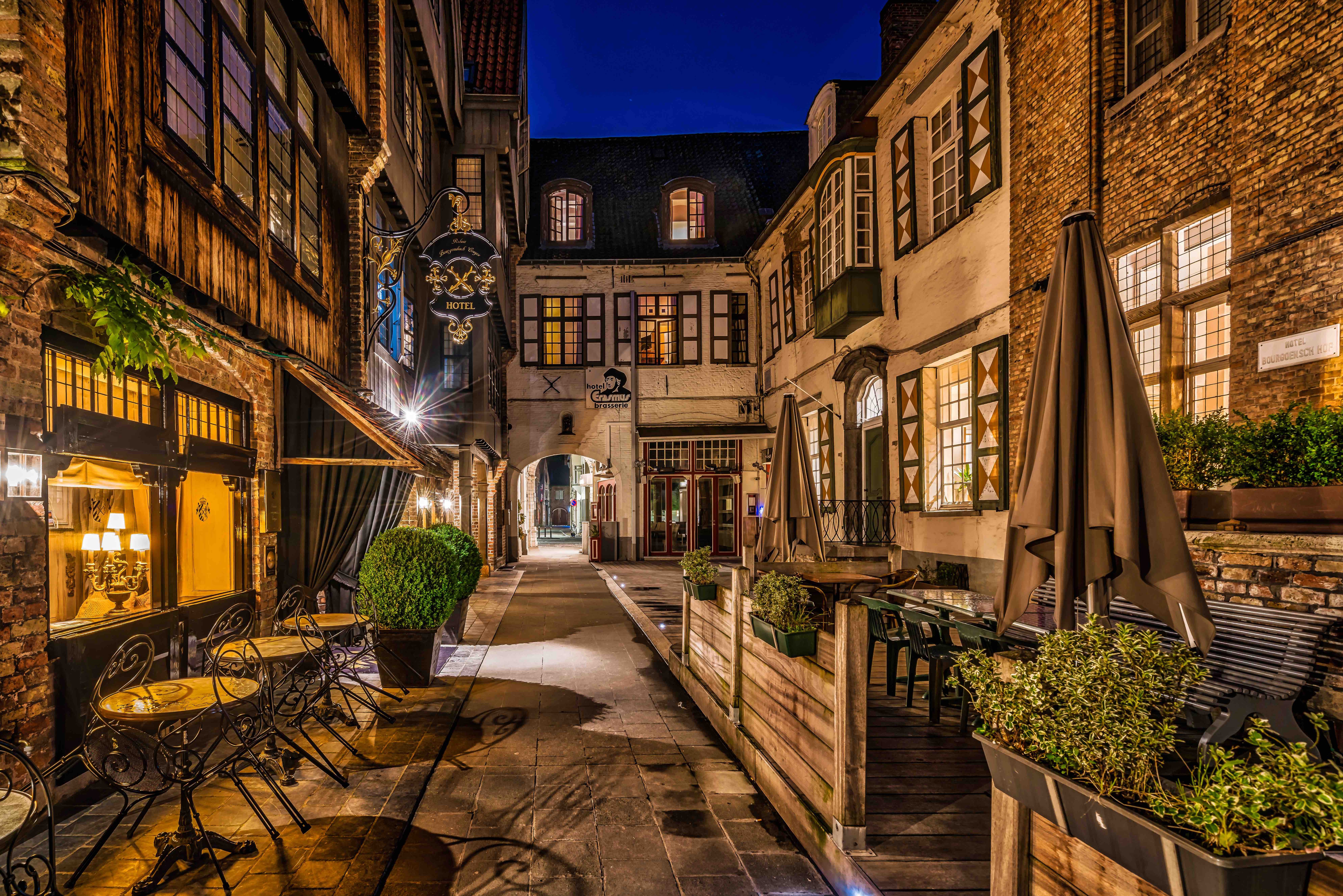Bruges street at night with hotel and cafe HD Wallpaper