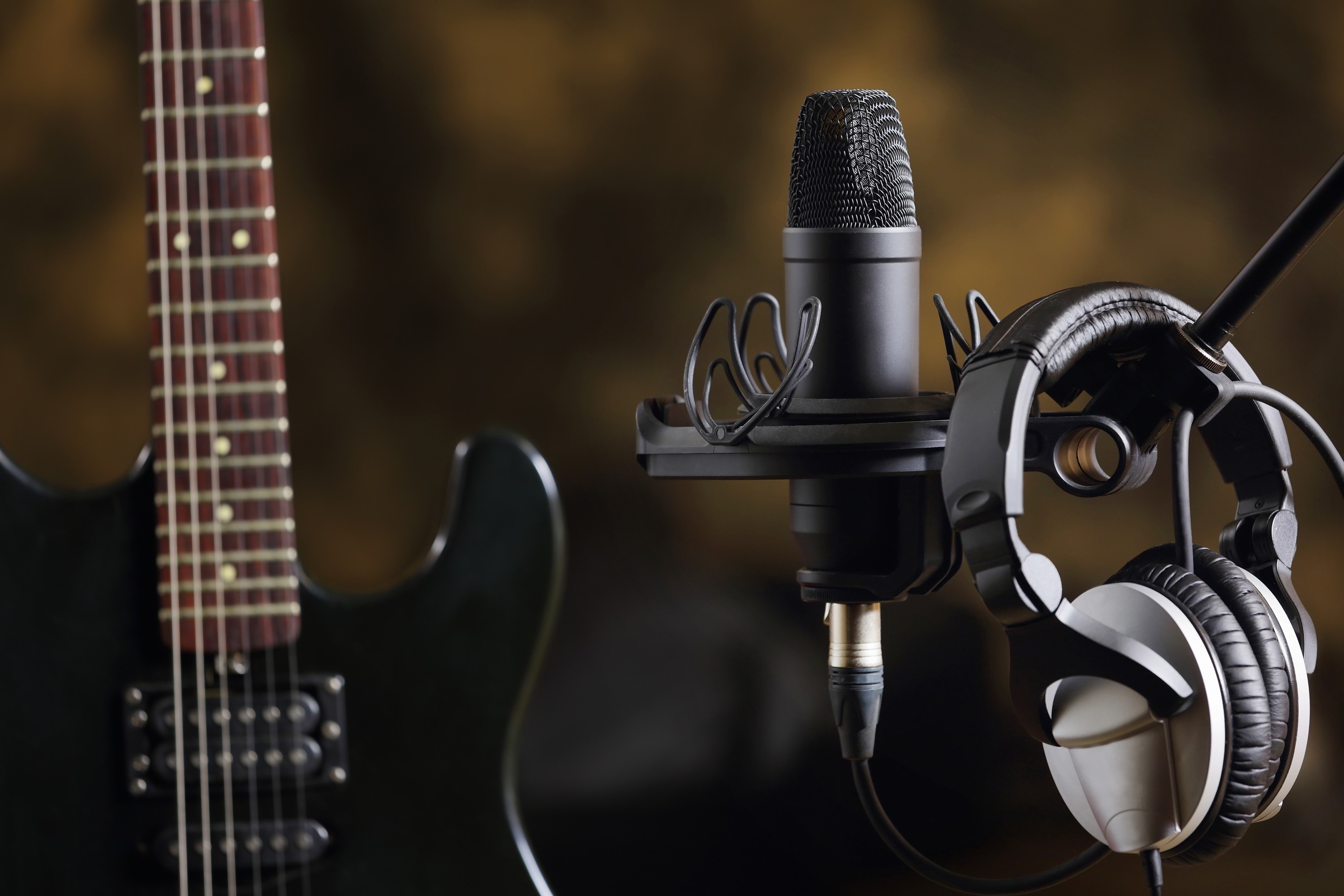 Electric guitar, microphone, and headphones in studio HD Wallpaper