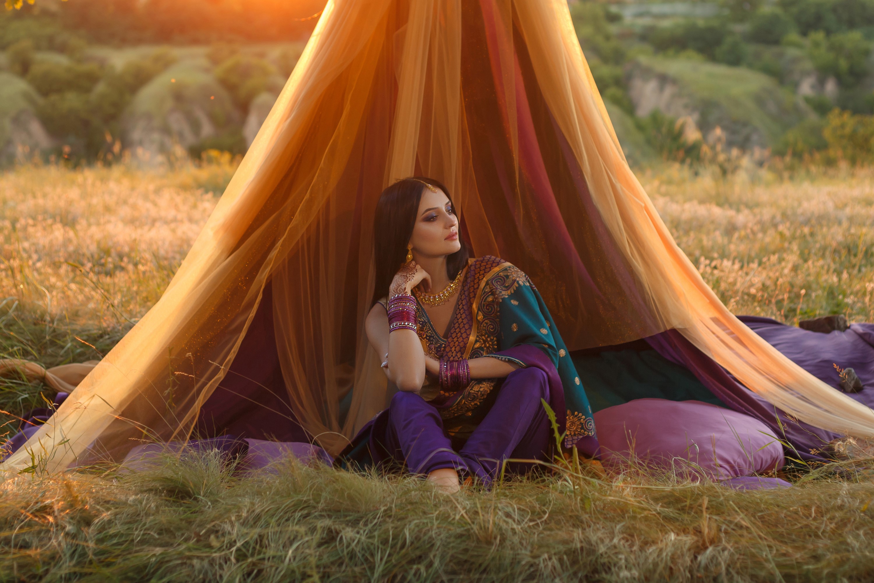 Woman in traditional Indian attire sitting under a canopy HD Wallpaper