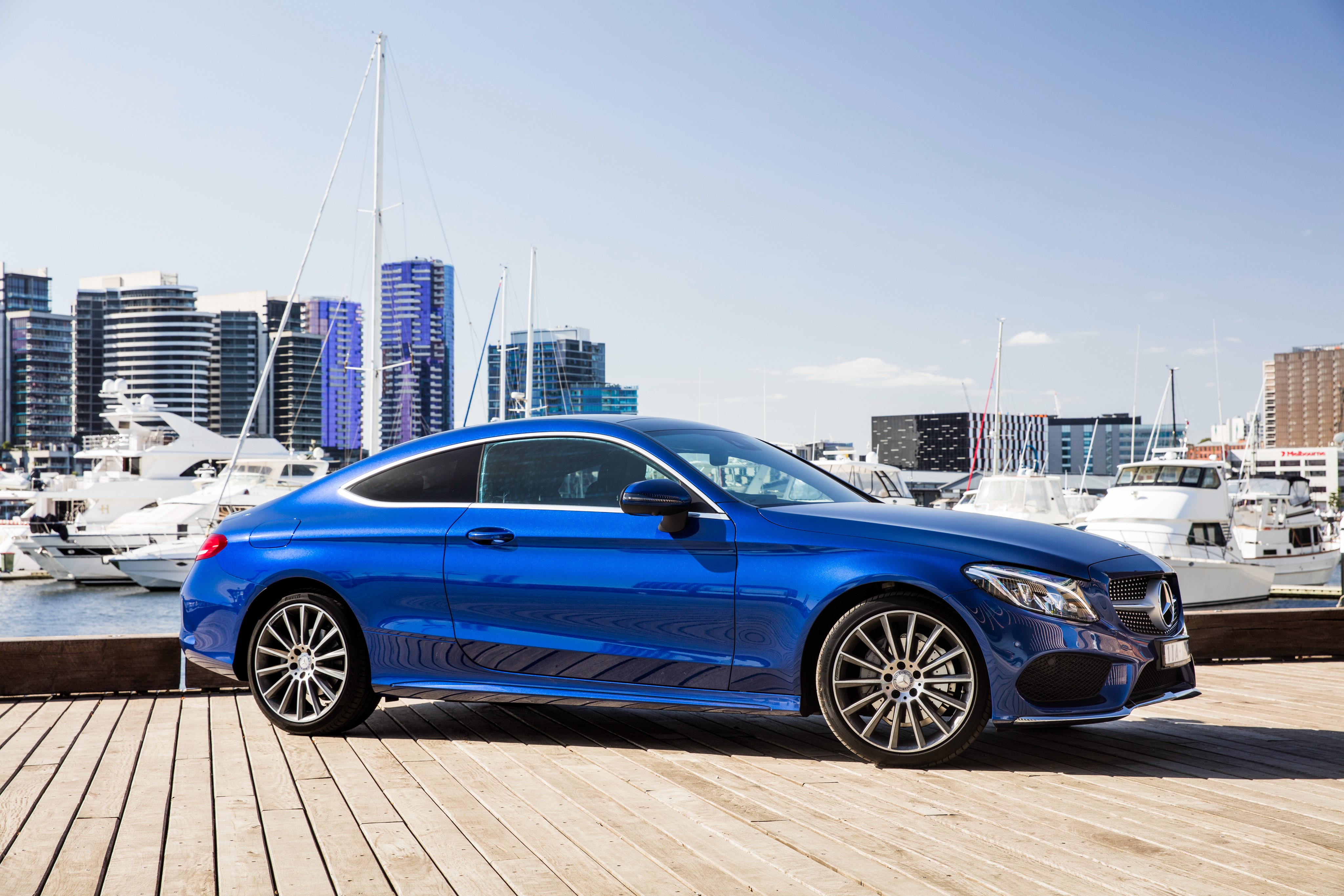 Blue Mercedes-Benz C-Class Coupe parked by a marina HD Wallpaper