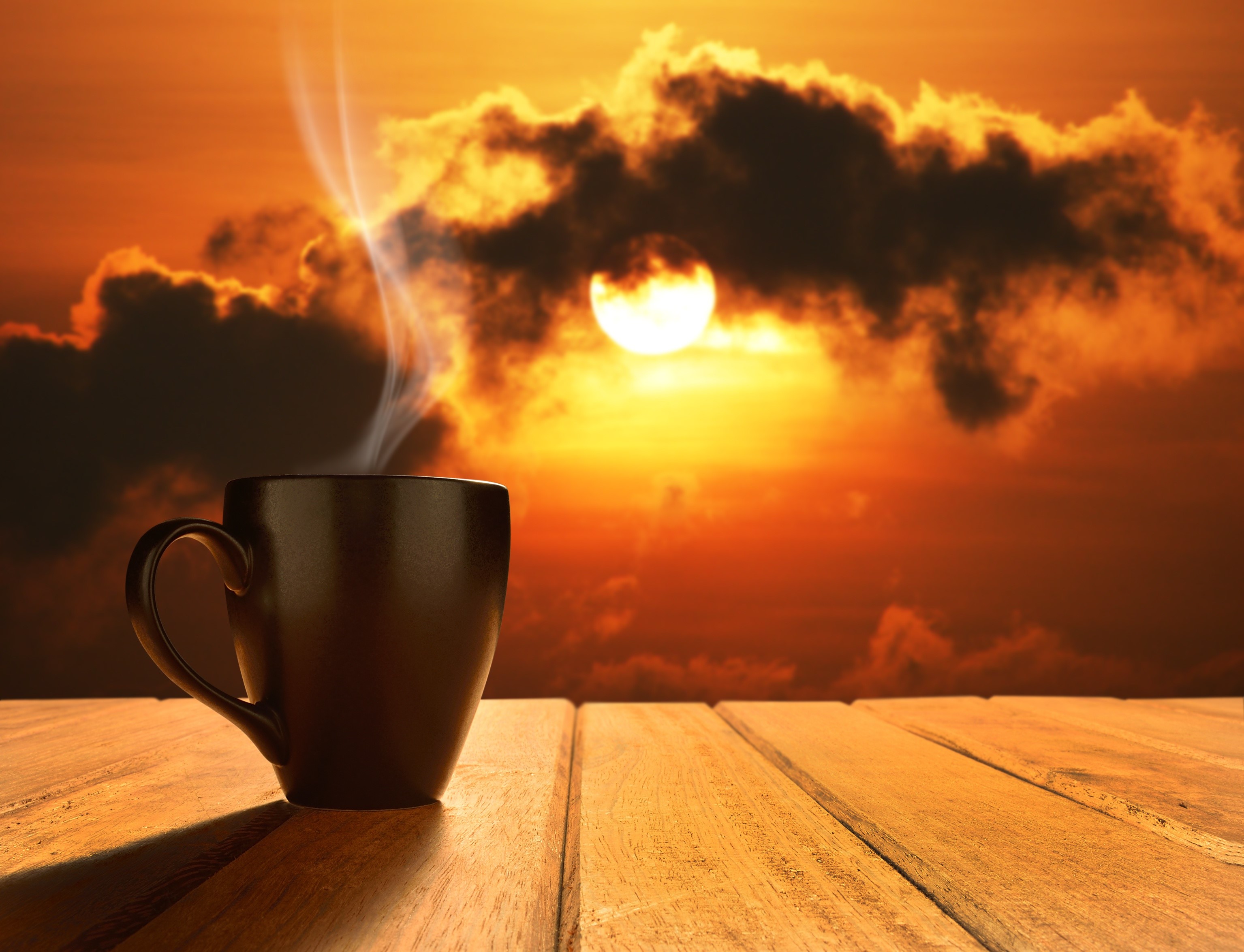 Cup of steaming coffee at sunrise HD Wallpaper