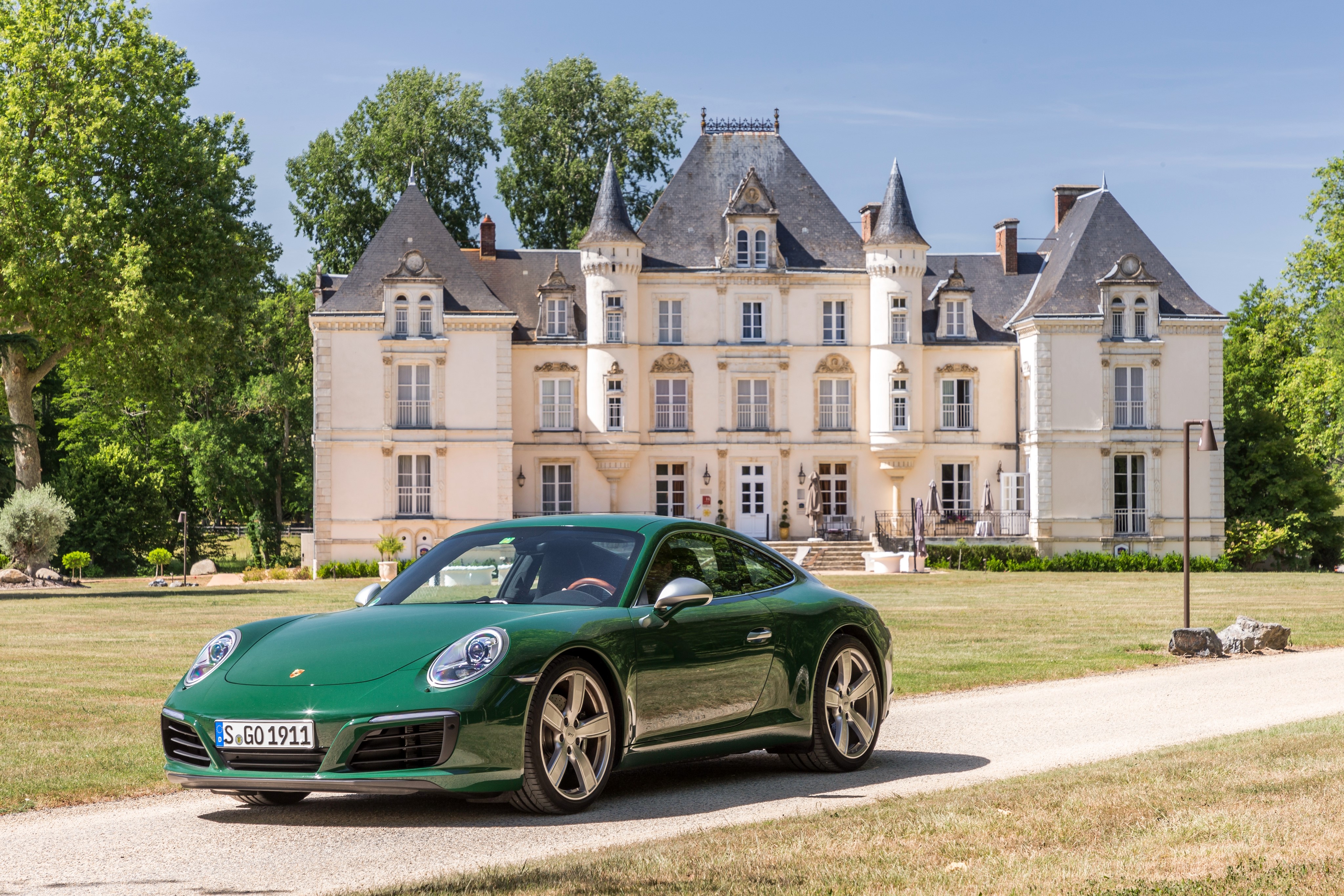 Green Porsche 911 Carrera S Coupe in front of a chateau HD Wallpaper
