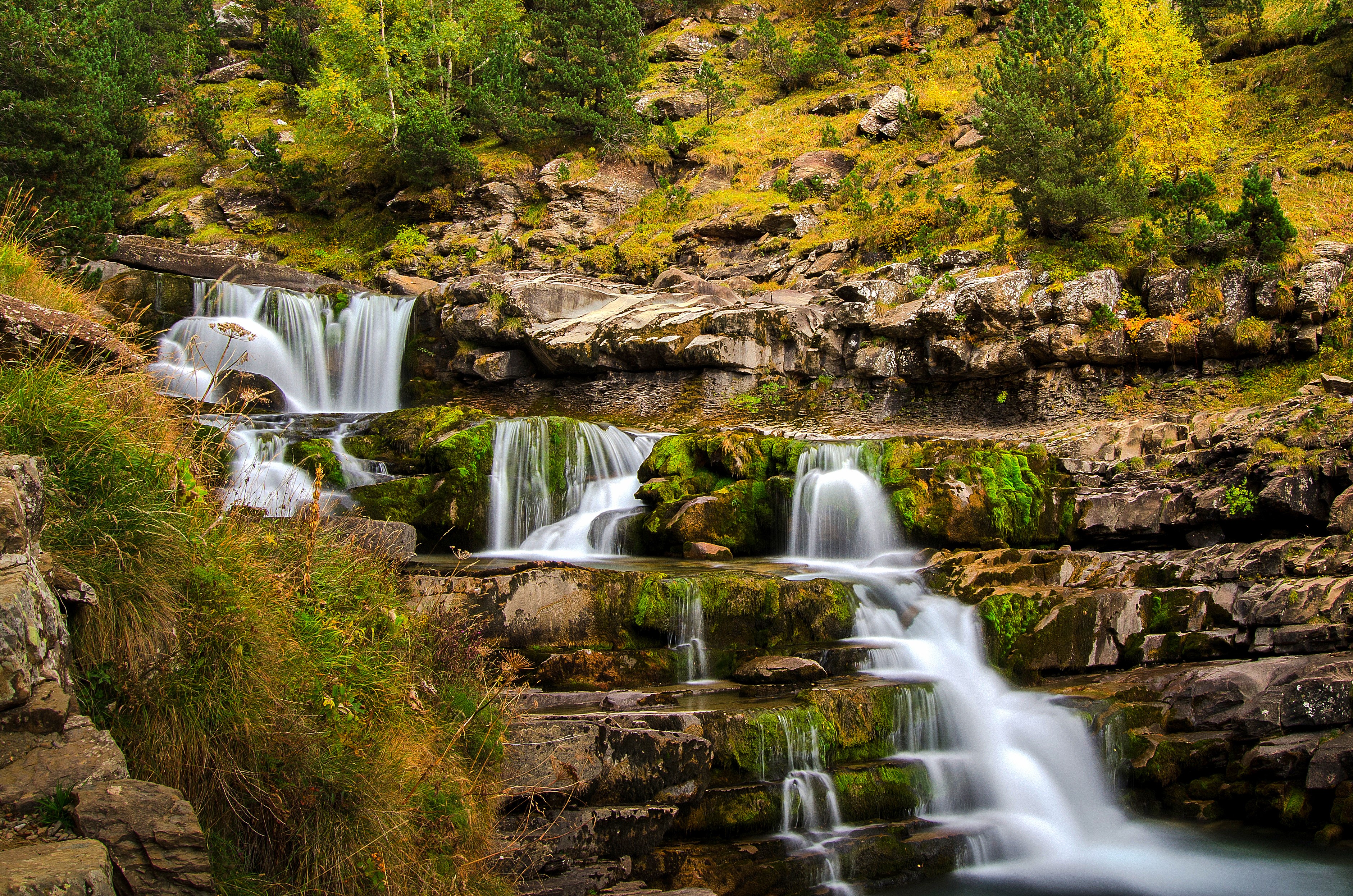 Waterfalls cascading over mossy rocks in Ordesa, Aragon, Spain HD Wallpaper