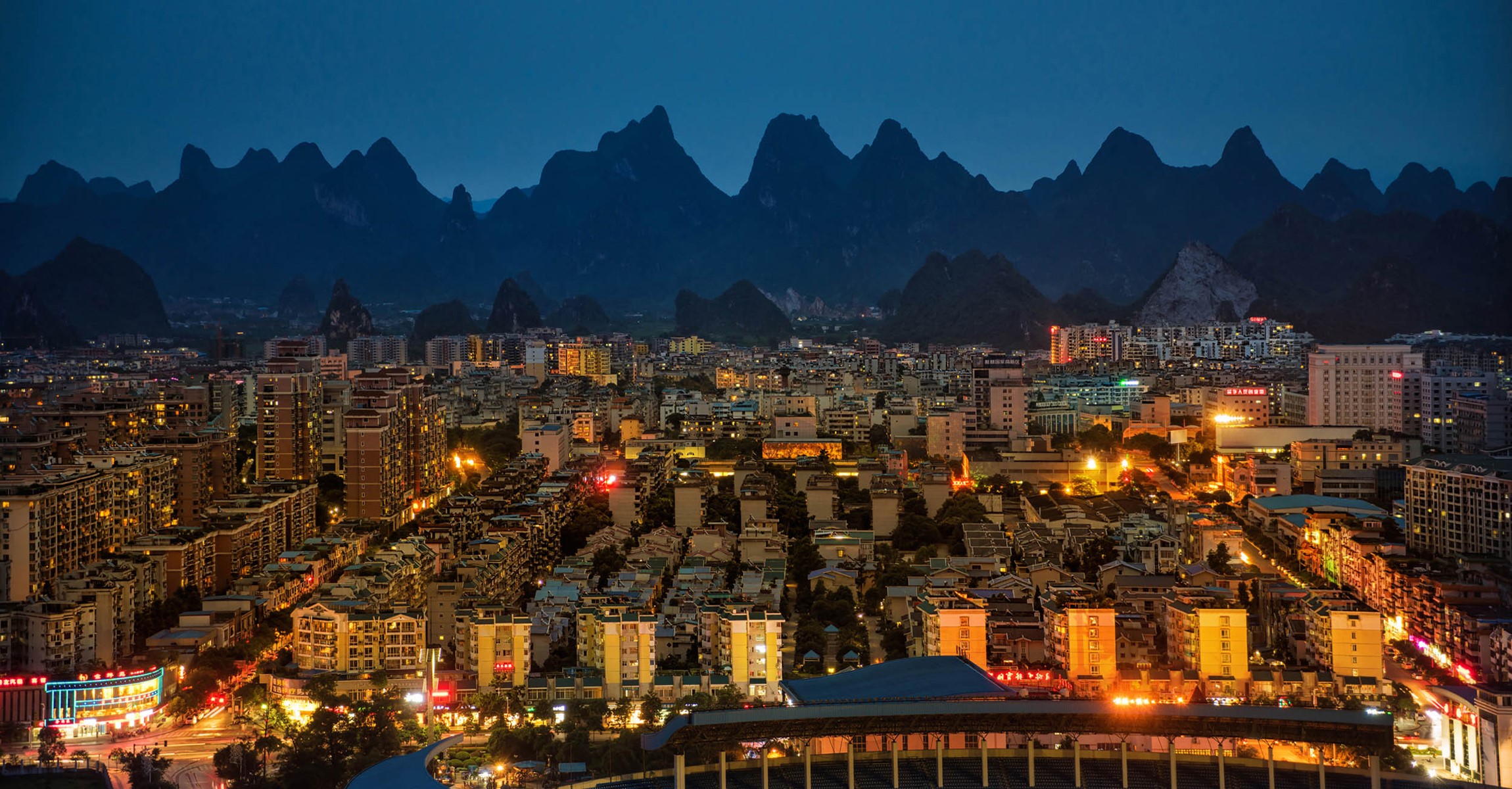 Yangshuo, China at night with mountains HD Wallpaper