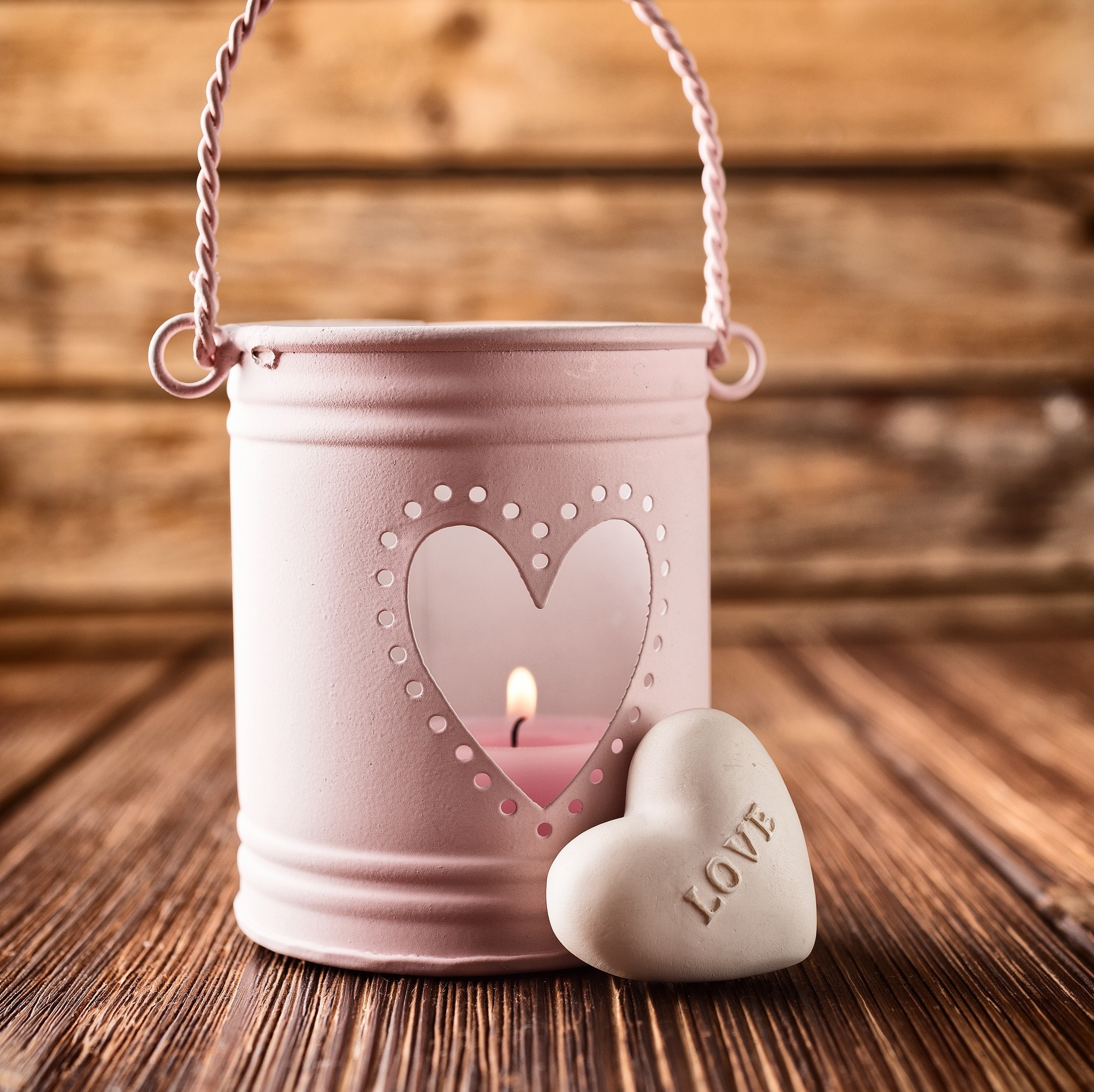 Pink heart lantern with lit candle and 'Love' heart decoration HD Wallpaper