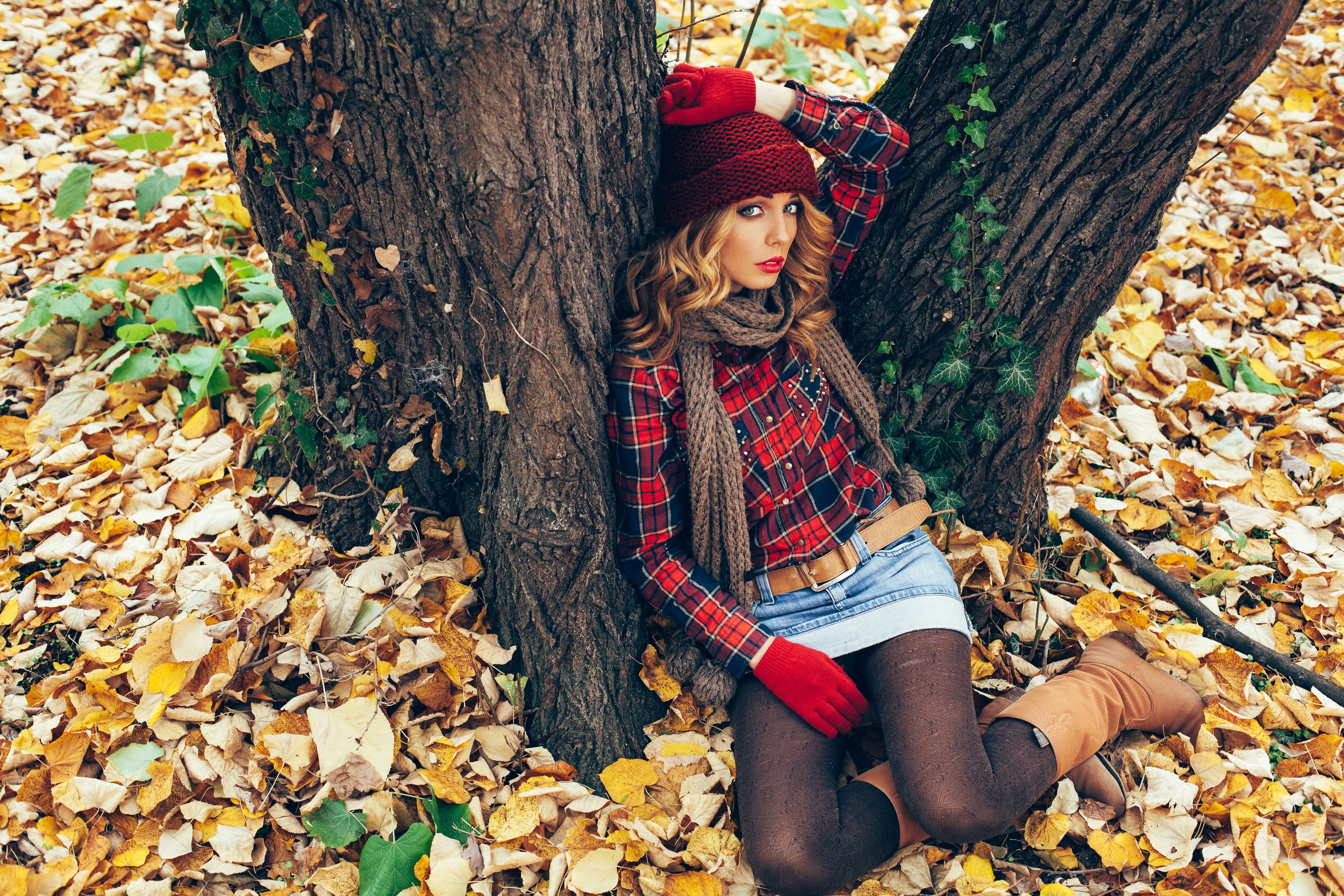 Woman in red hat and plaid shirt in autumn foliage HD Wallpaper