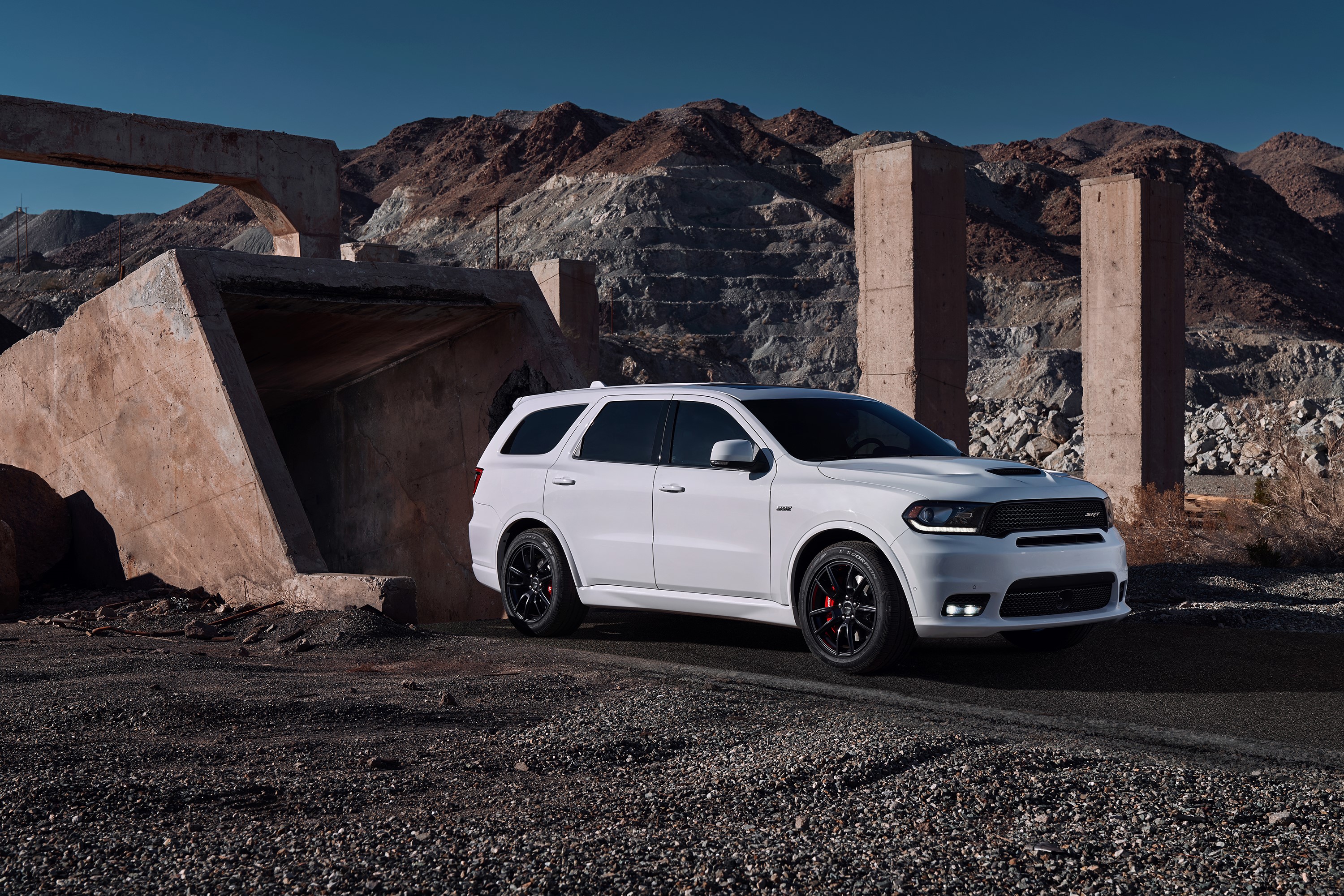 White Dodge Durango SRT in a rocky, industrial landscape HD Wallpaper