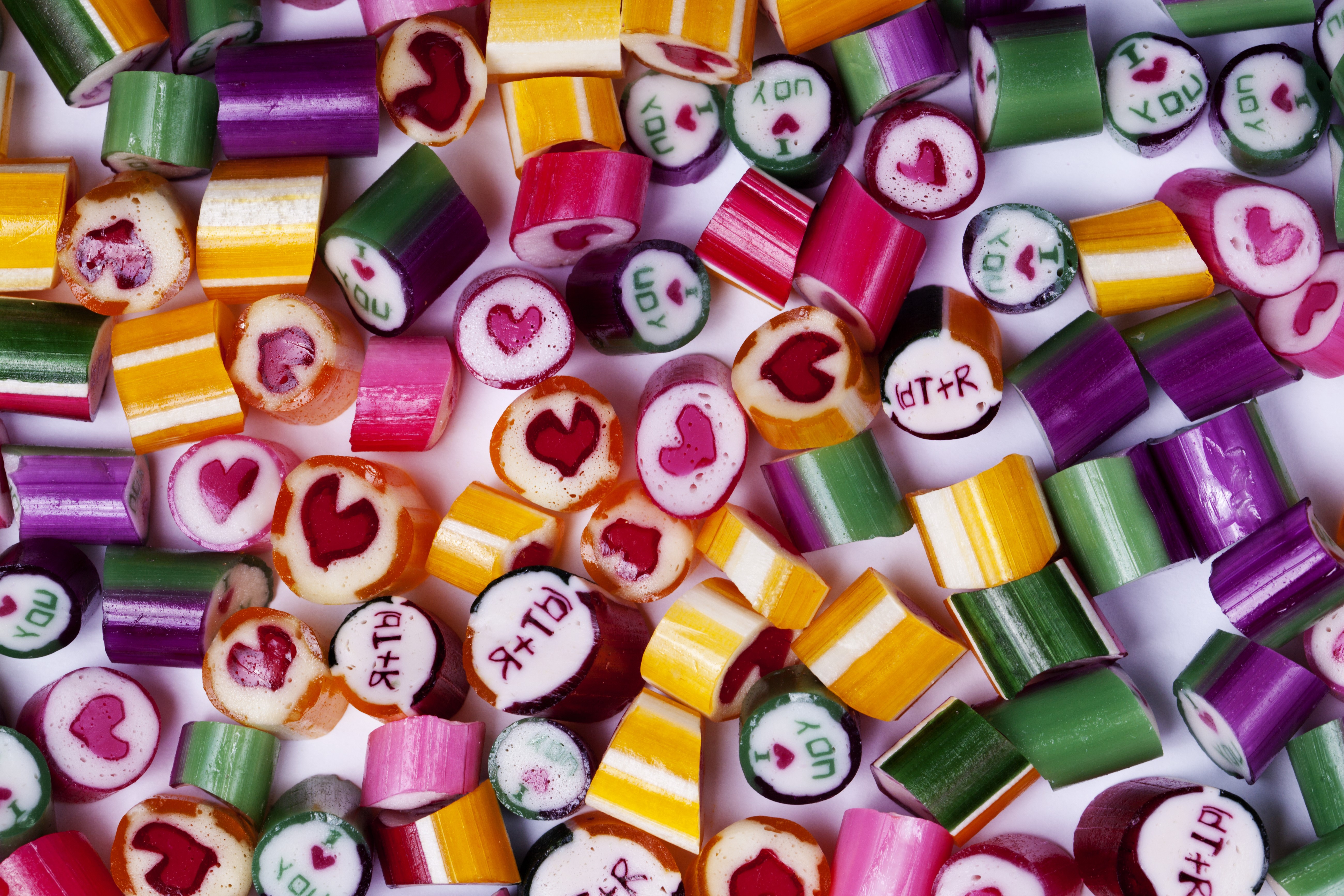 Many colorful candies with hearts and text HD Wallpaper