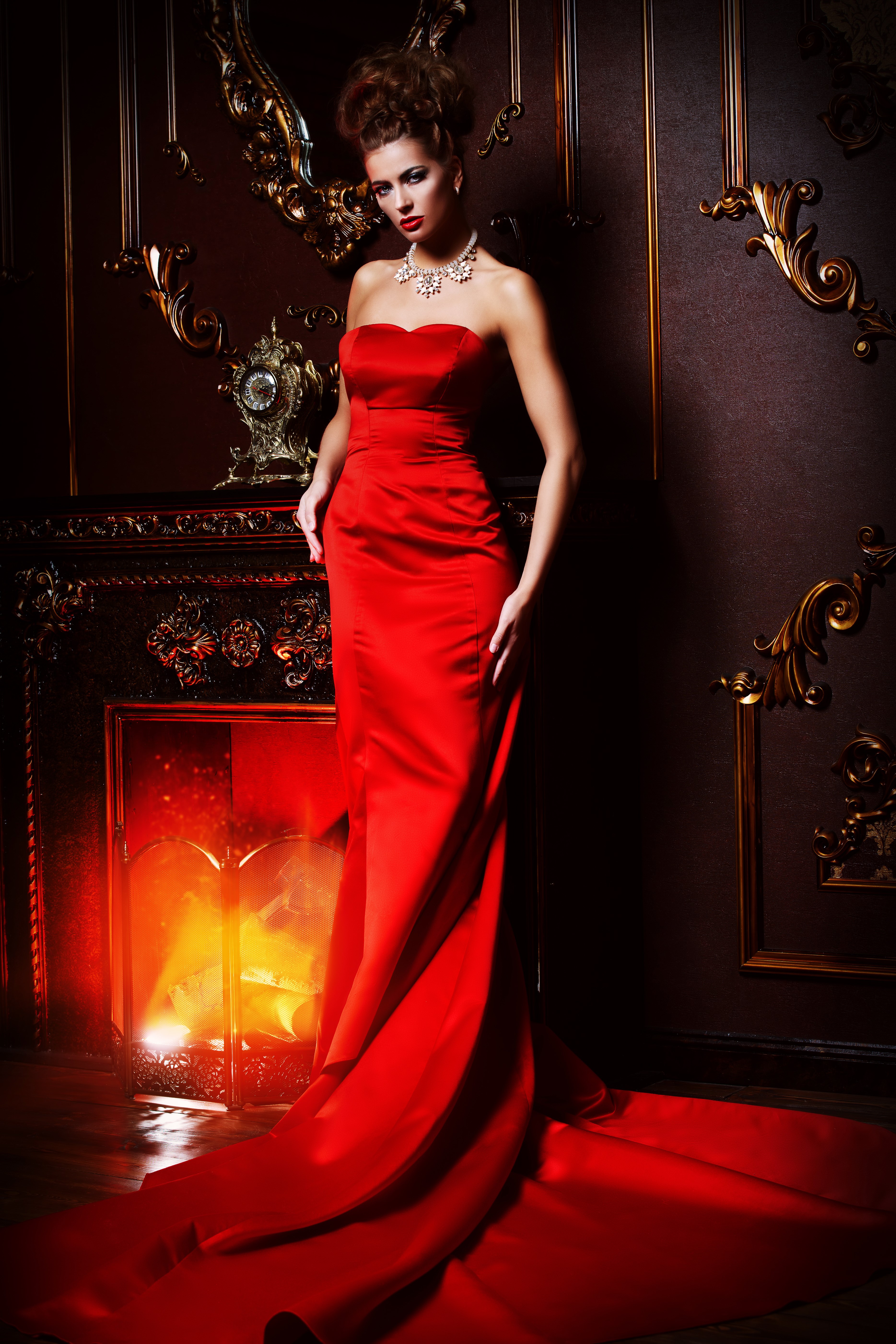 Woman in red dress by fireplace HD Phone Wallpaper