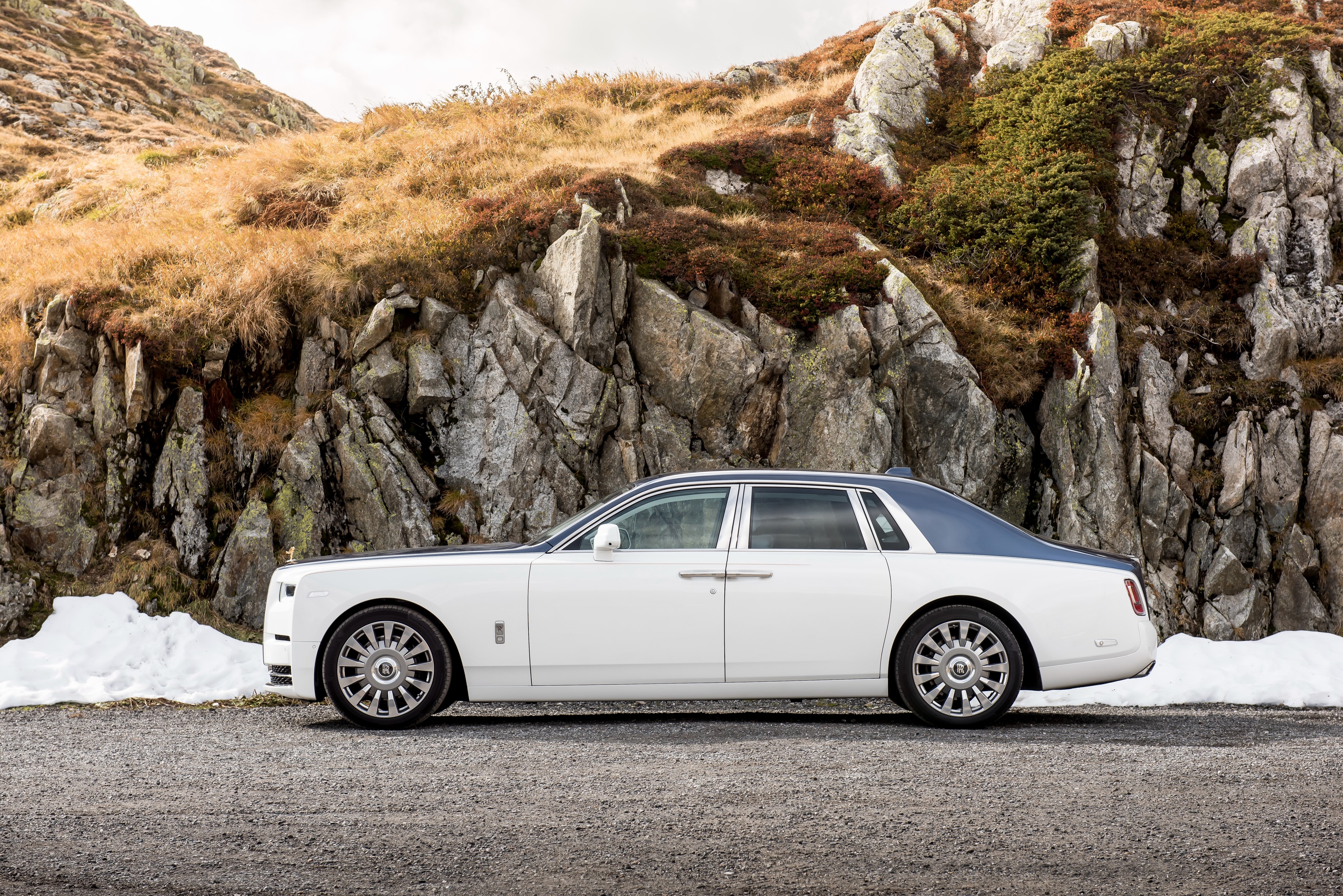 White Rolls-Royce Phantom parked on a rocky mountain road HD Wallpaper