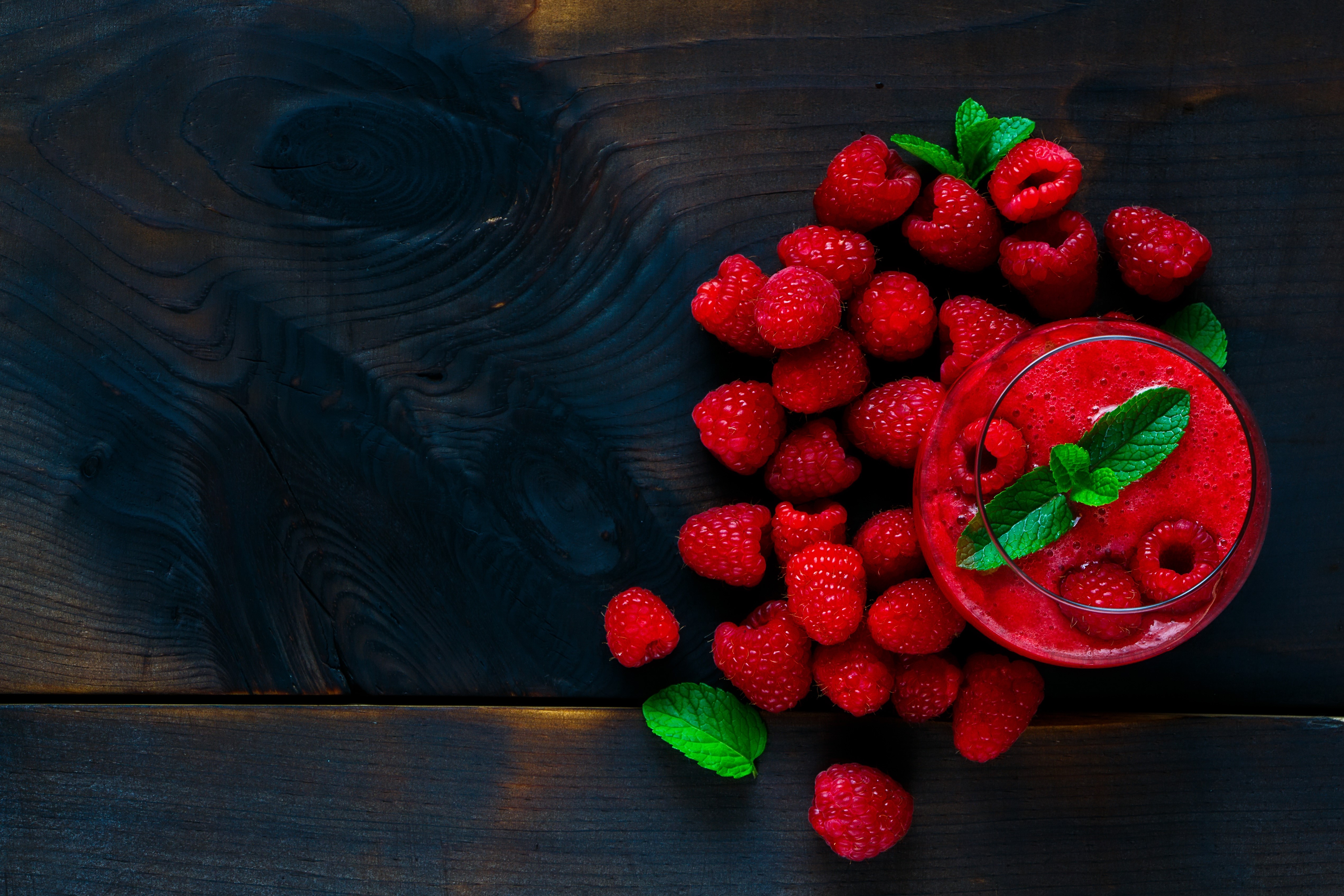Raspberry smoothie with fresh raspberries and mint on dark wood HD Wallpaper