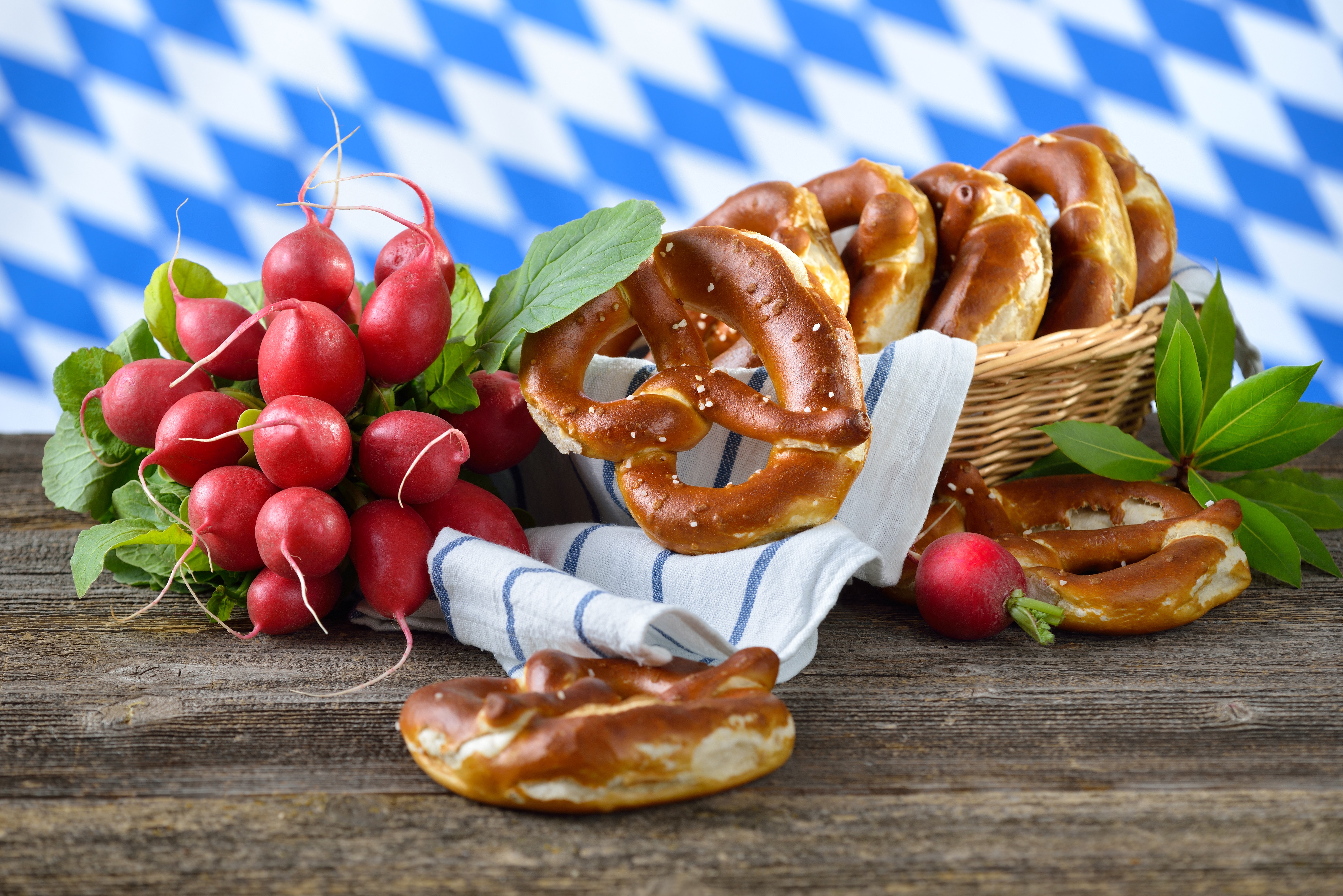 Radishes and pretzels on a wooden table HD Wallpaper