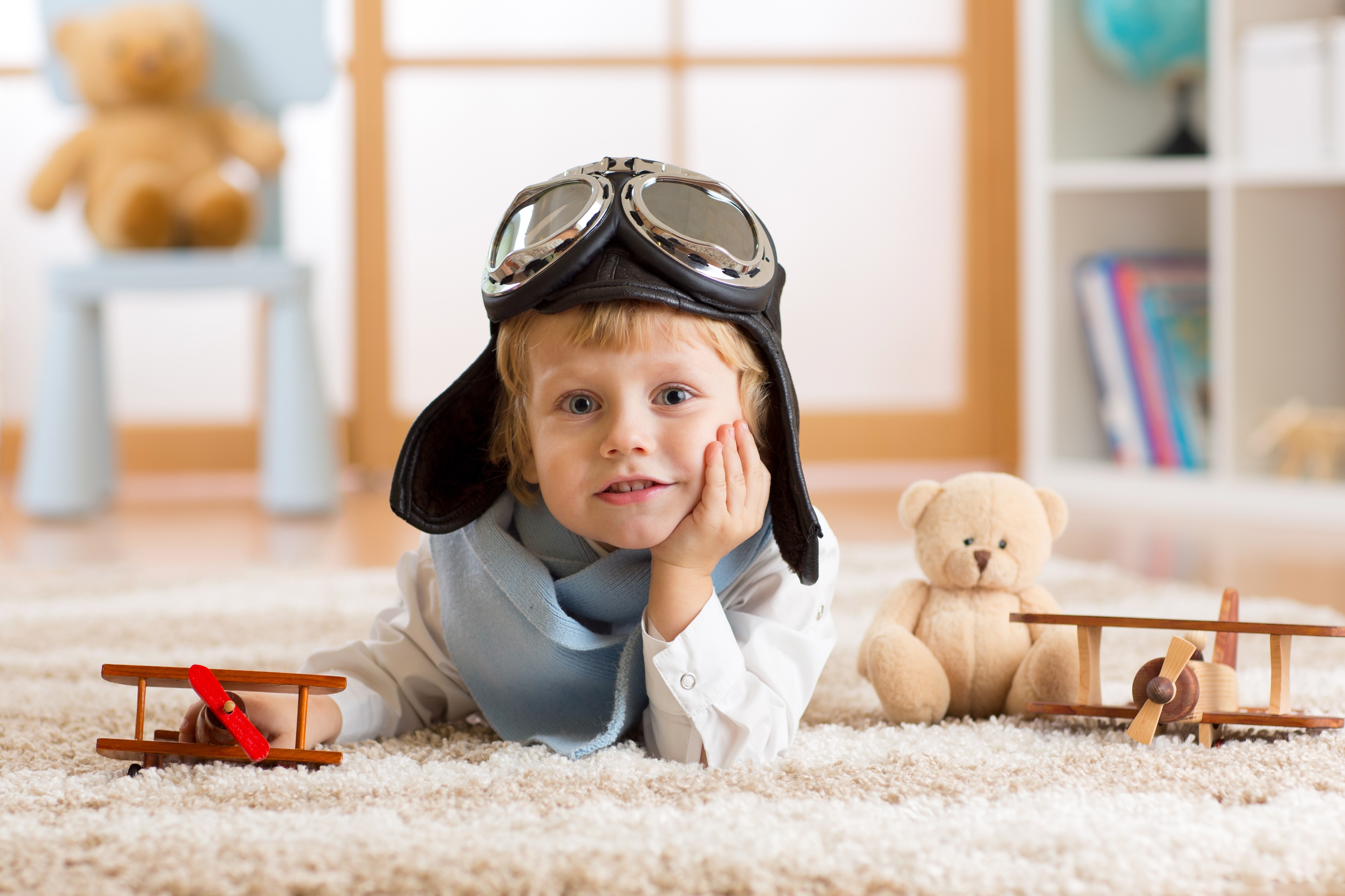 Boy in pilot hat with toy airplanes and teddy bear HD Wallpaper