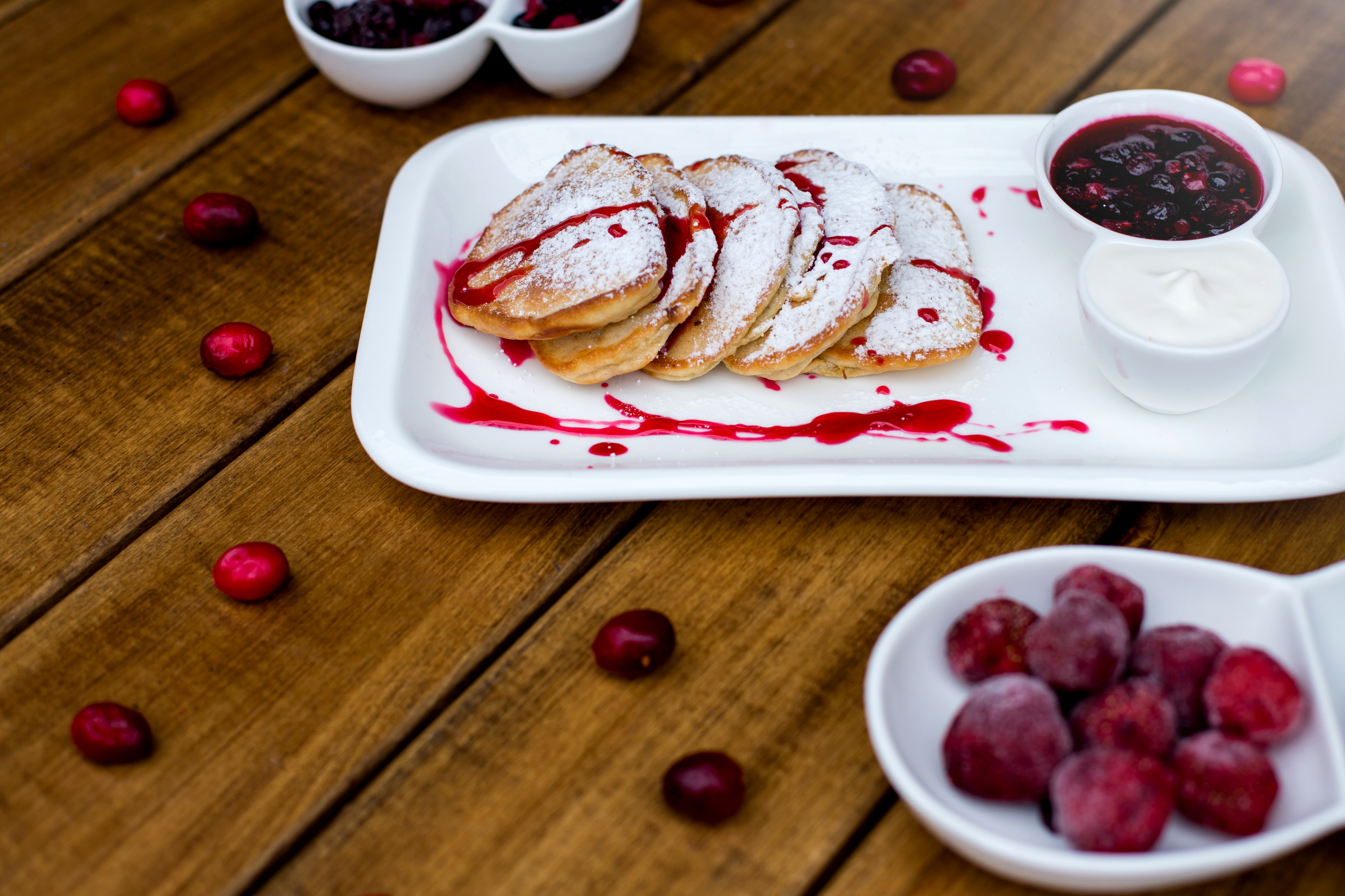 Pancakes with jam and cream on wooden planks HD Wallpaper