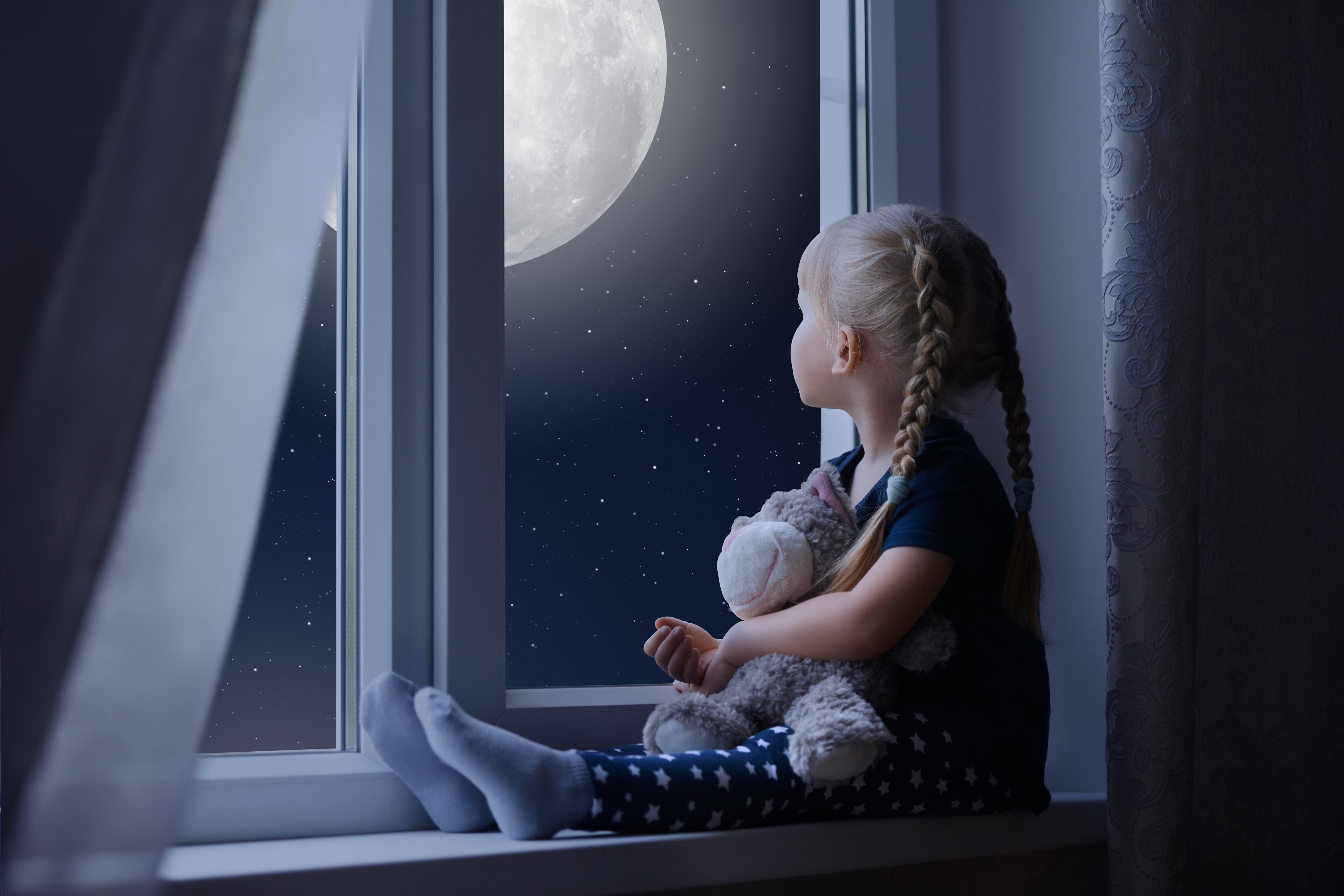 Little girl sitting by the window at night HD Wallpaper