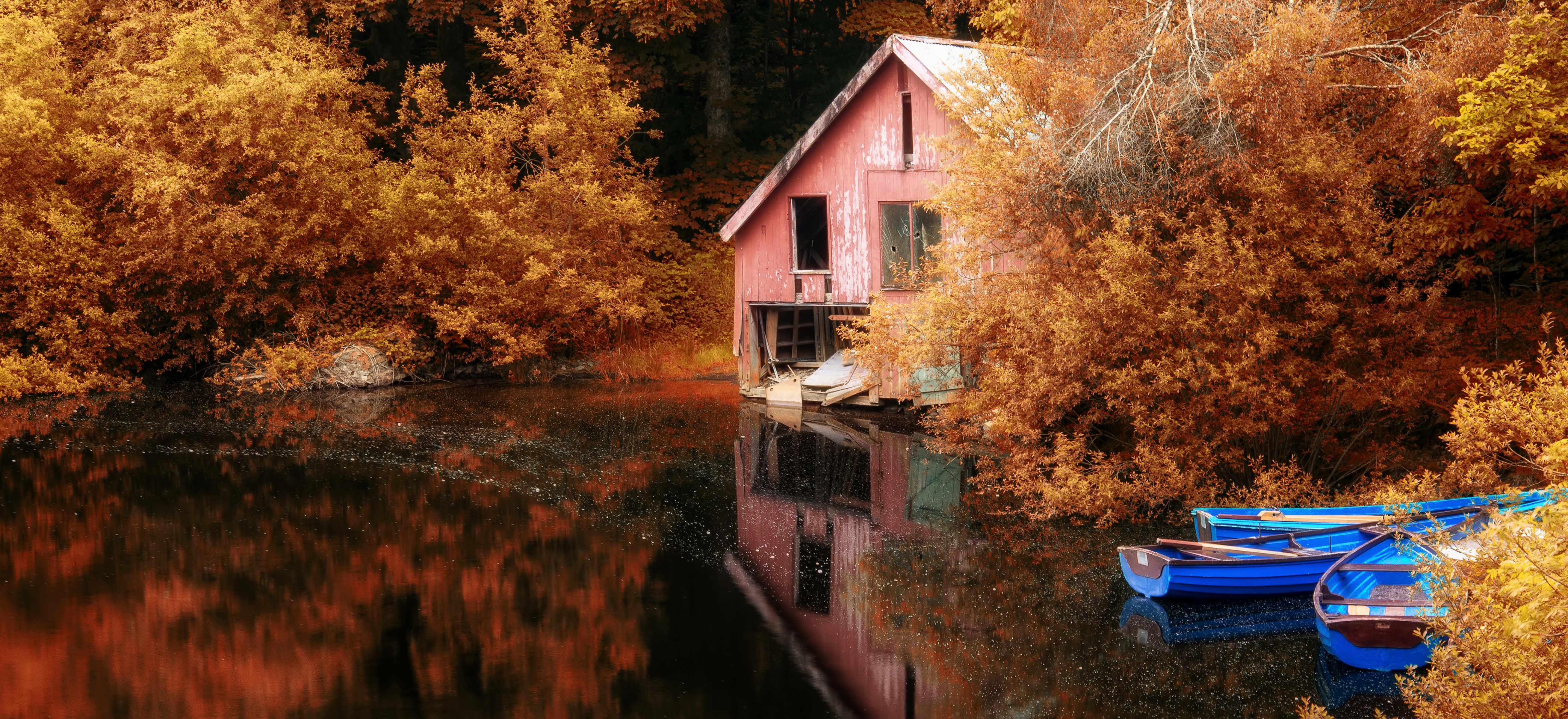 Boathouse on a lake in autumn with boats HD Wallpaper