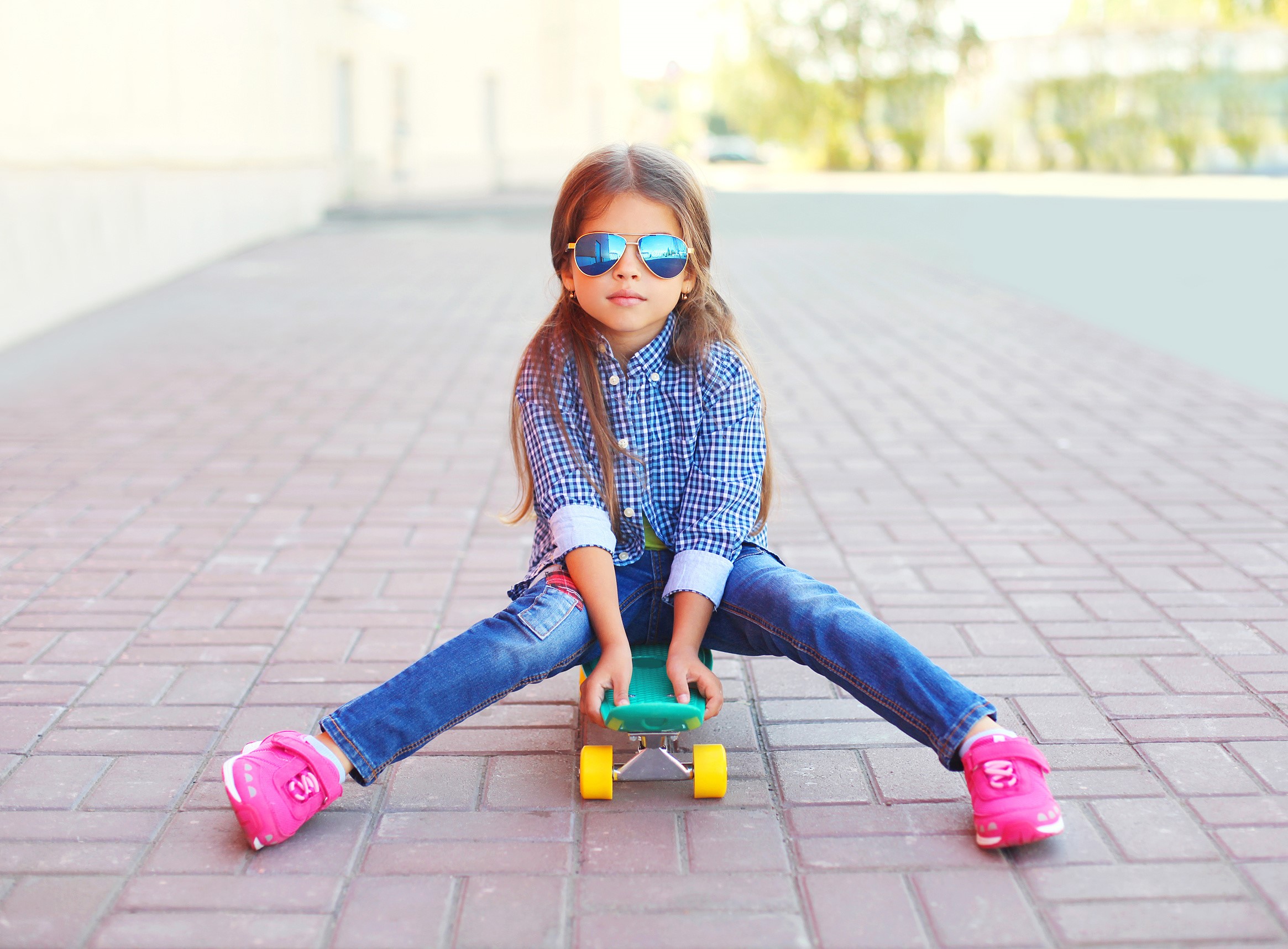 Girl in sunglasses sitting on a skateboard HD Wallpaper