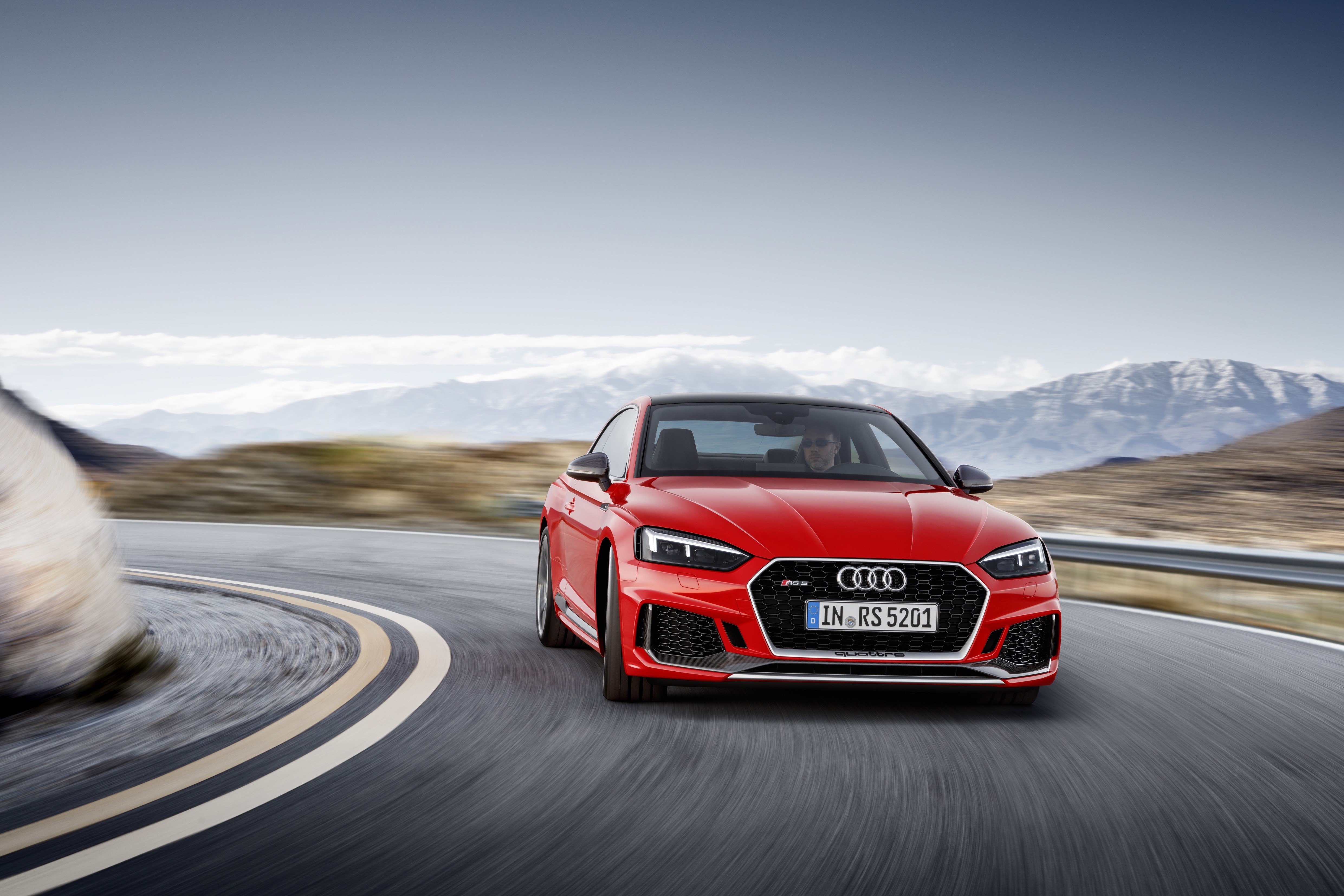 Red Audi RS5 Coupe driving on a mountain road HD Wallpaper