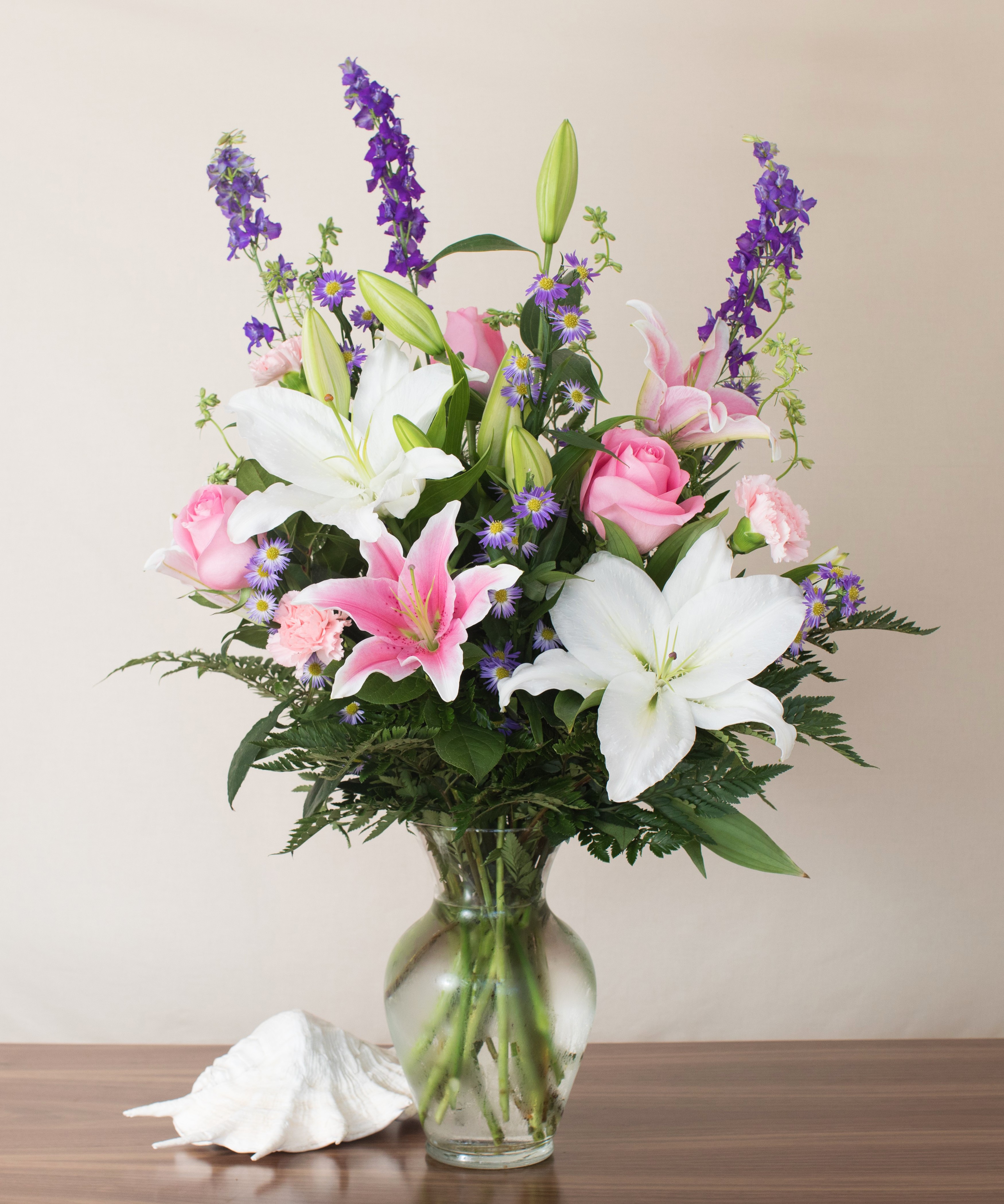 Floral arrangement with lilies, roses, and delphiniums in a vase HD Wallpaper