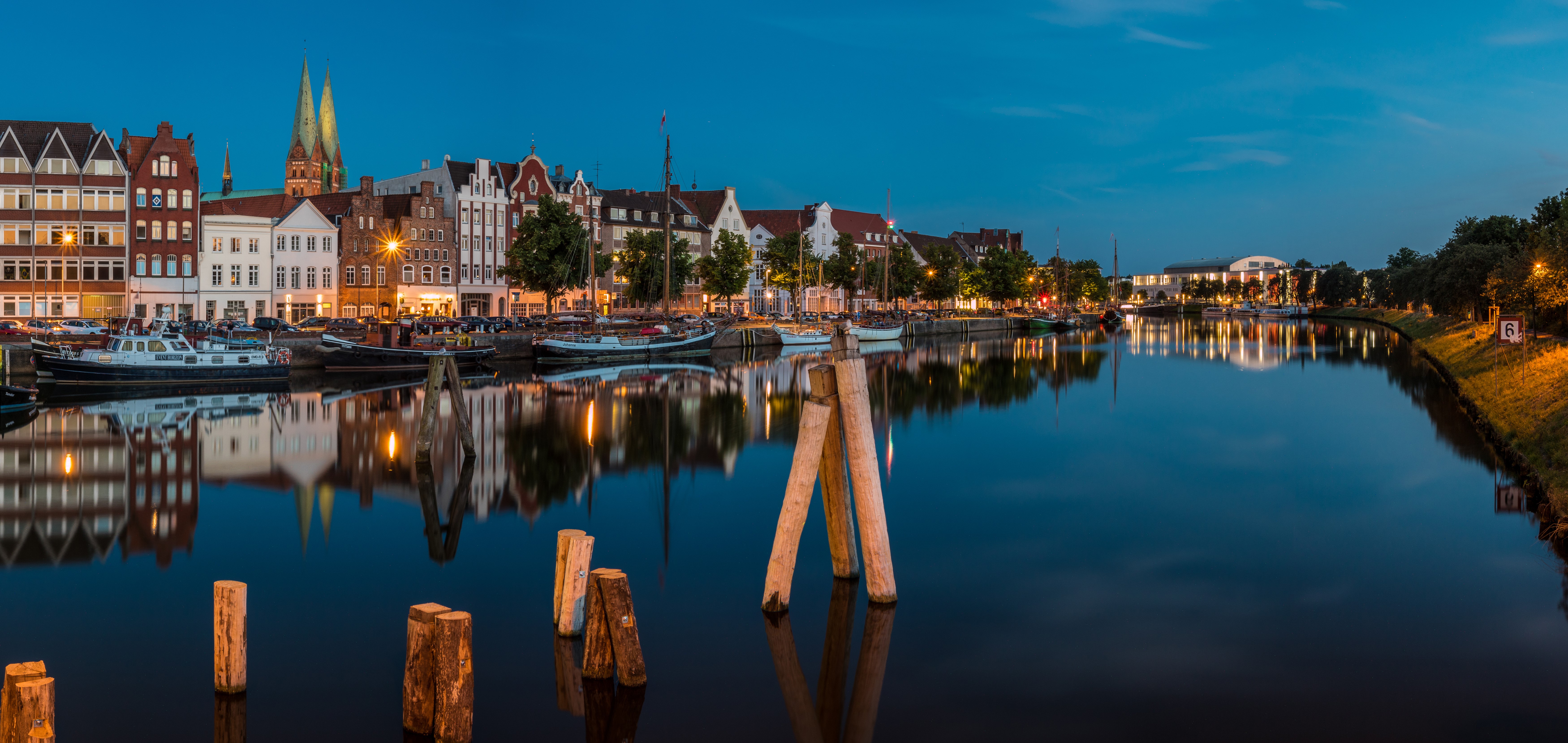 Luebeck Germany Riverfront Evening with Houses and Boats HD Wallpaper
